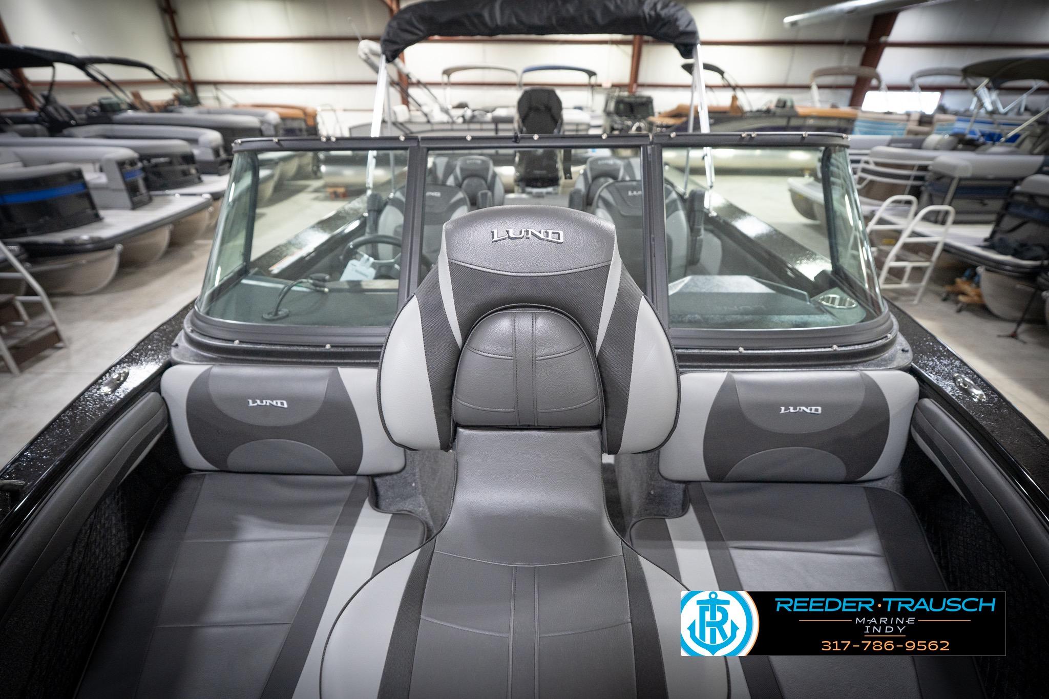 2026 Lund 2275 Baron boat interior with gray seating in showroom.