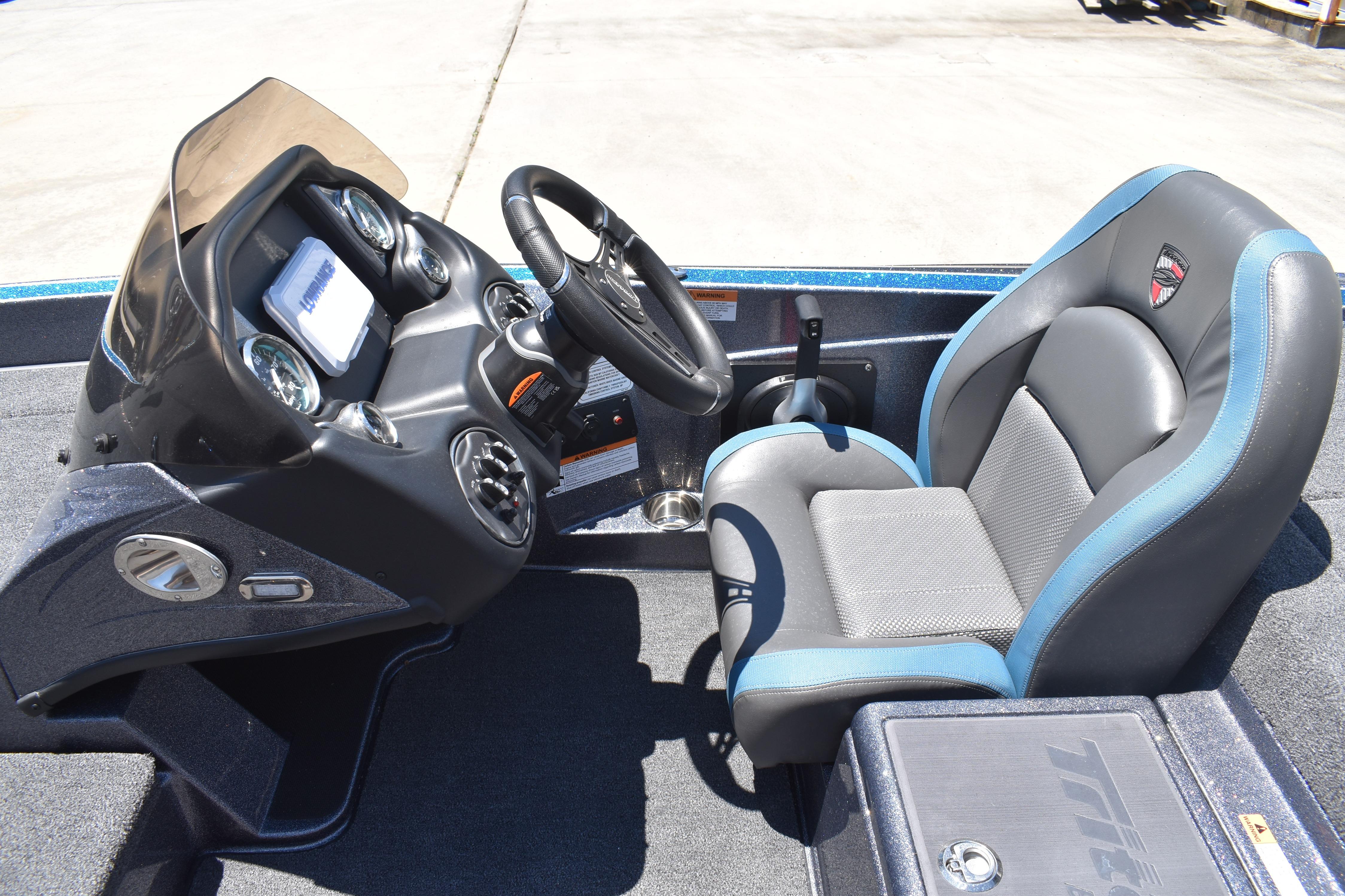 2026 Triton 179 TrX boat cockpit with steering wheel and cushioned seat.