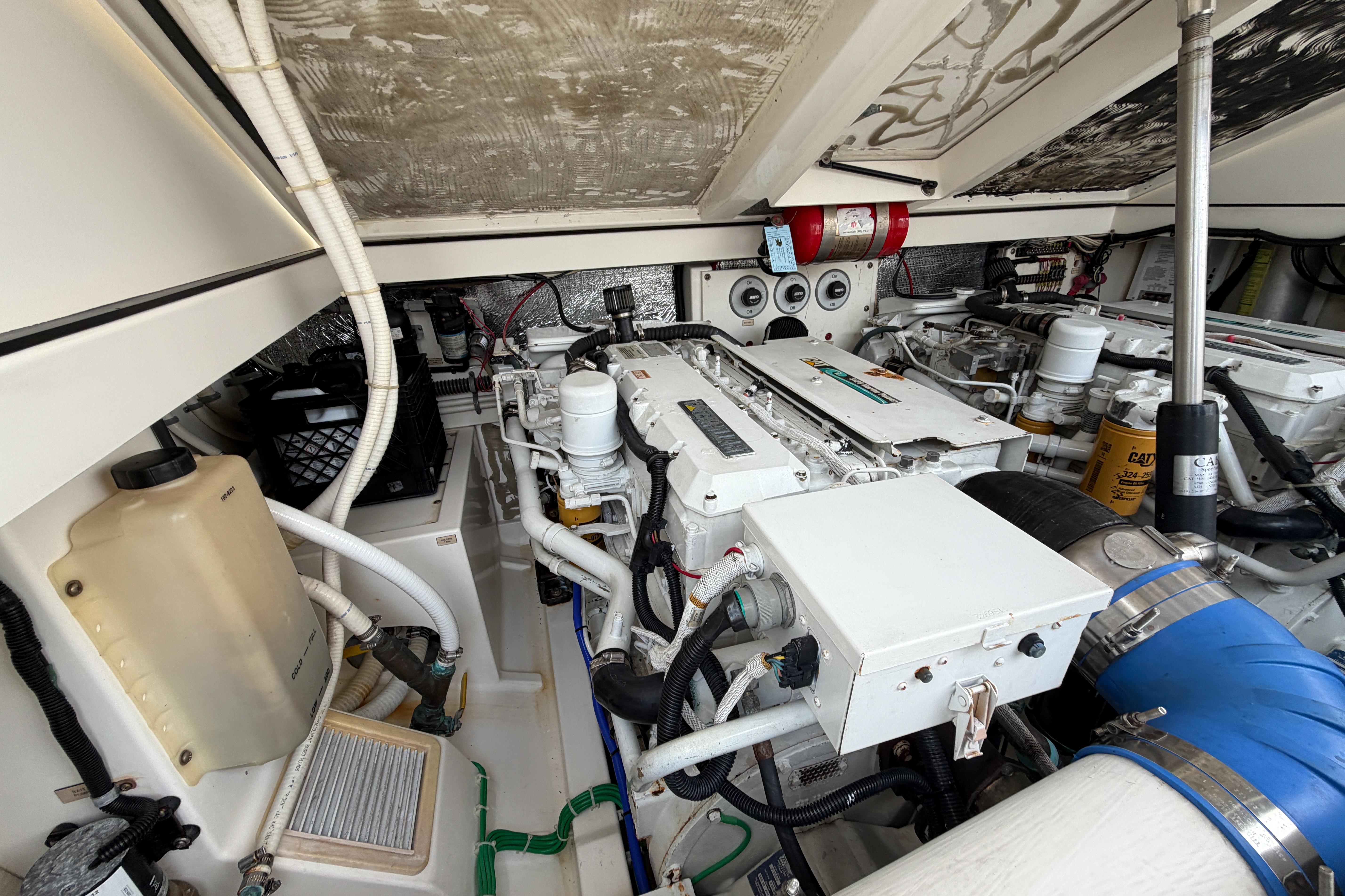 Engine room of a 1998 Cabo 31 Express boat, showcasing mechanical components and systems.