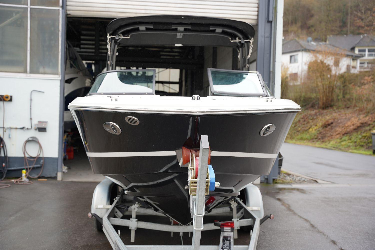 2023 Regal LS2 boat on trailer in garage, front view.
