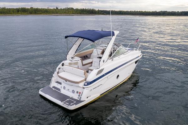 2016 Regal 28 Express boat on calm water with blue canopy.