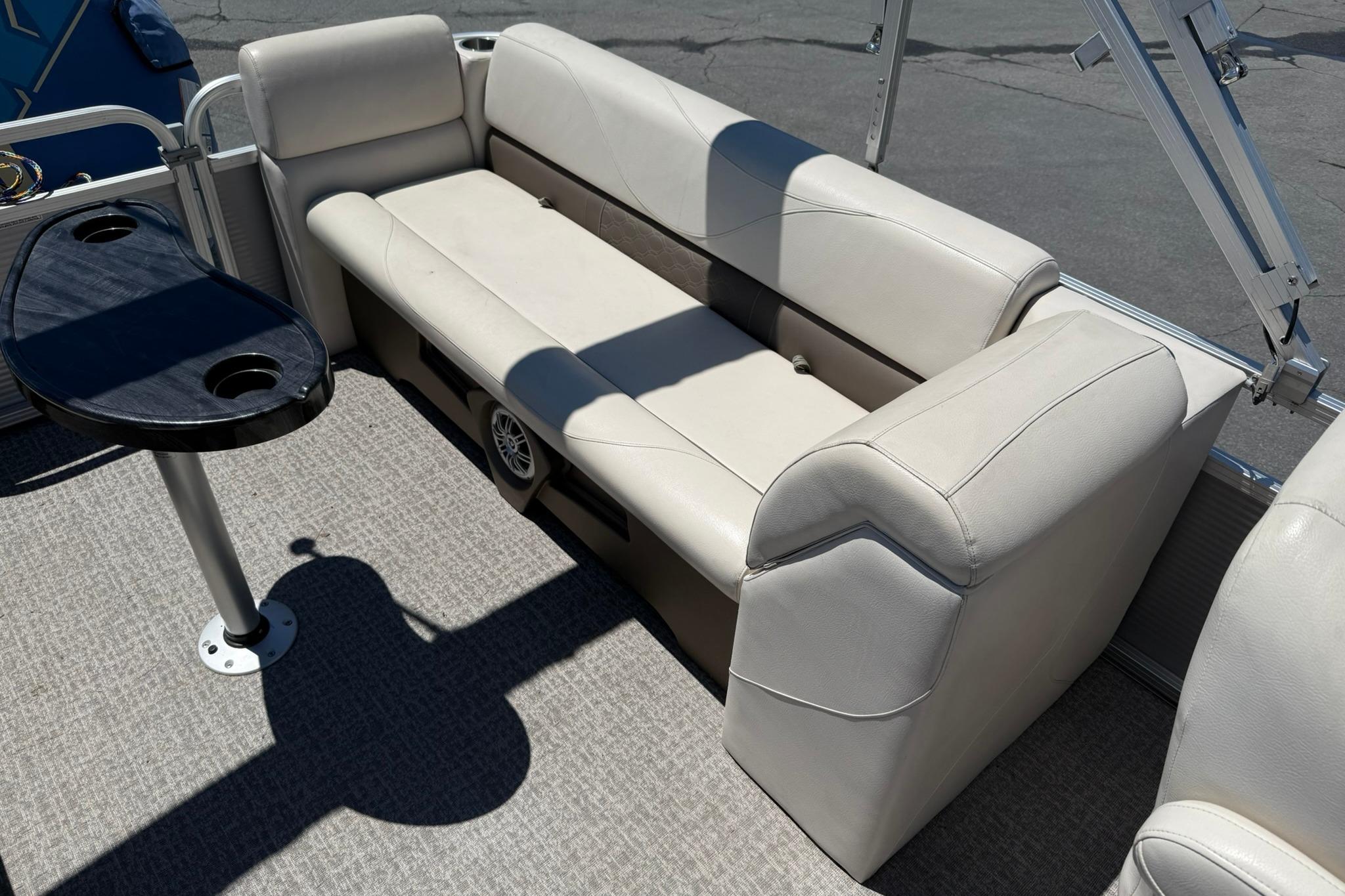 2019 Avalon GS Quad Lounge 25' boat interior with beige seating and a black table.