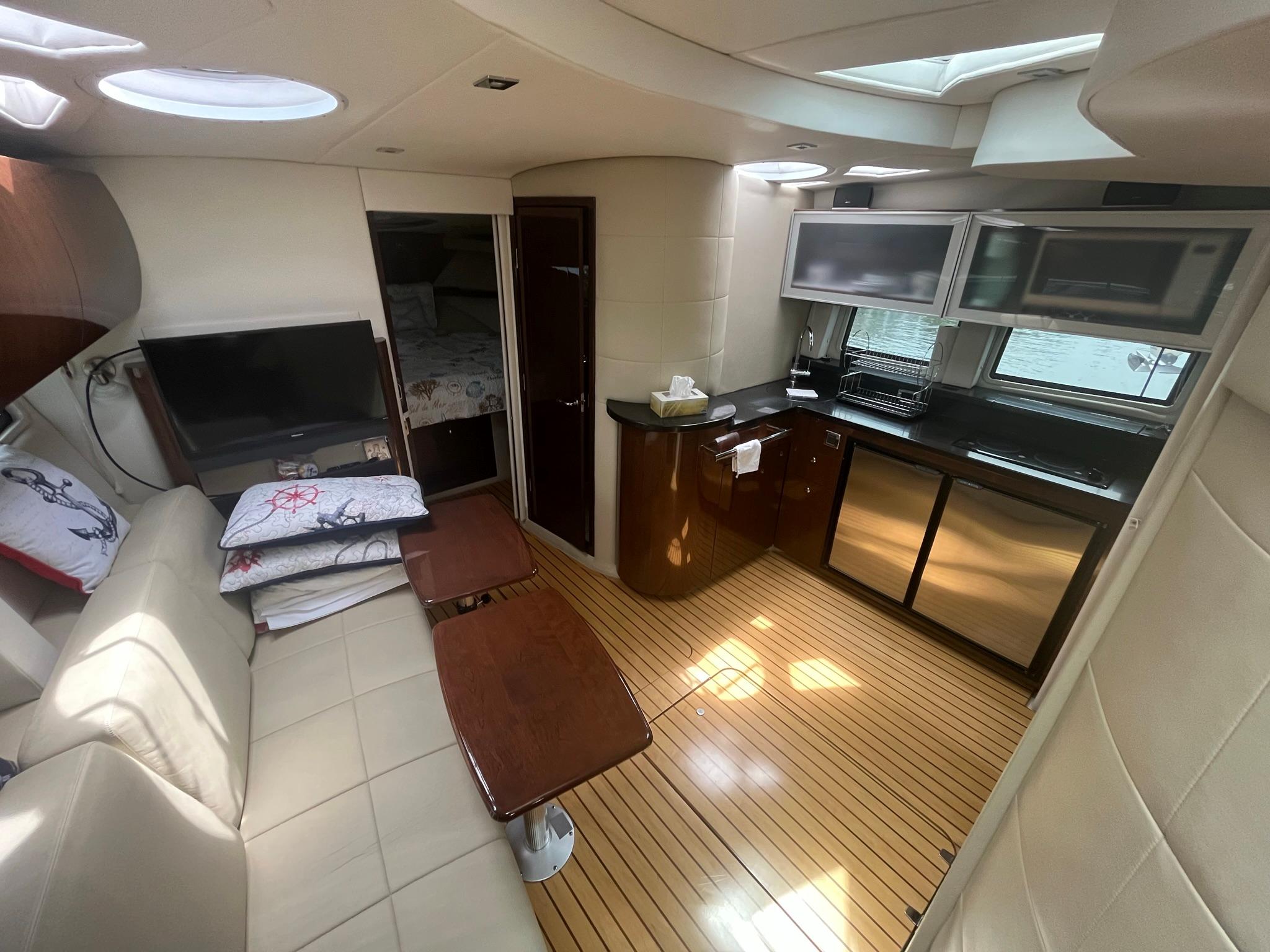 2012 Four Winns V435 yacht interior with modern kitchen and cozy seating area.