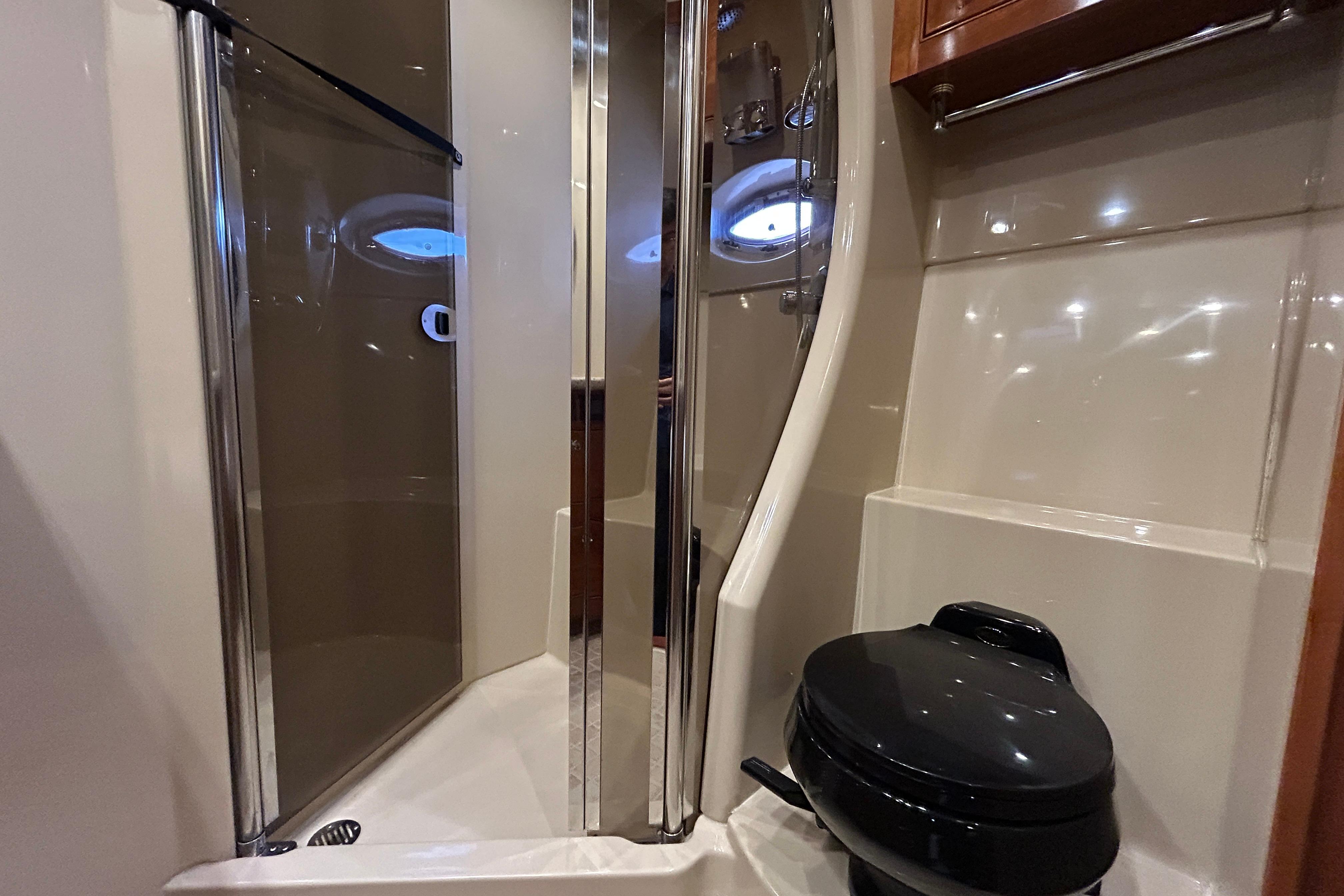 Luxurious bathroom in 2003 Cruisers Yachts 540 Express with shower and toilet.