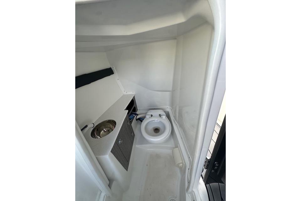 2022 Monterey 255SS Super Sport boat interior bathroom with sink and toilet.