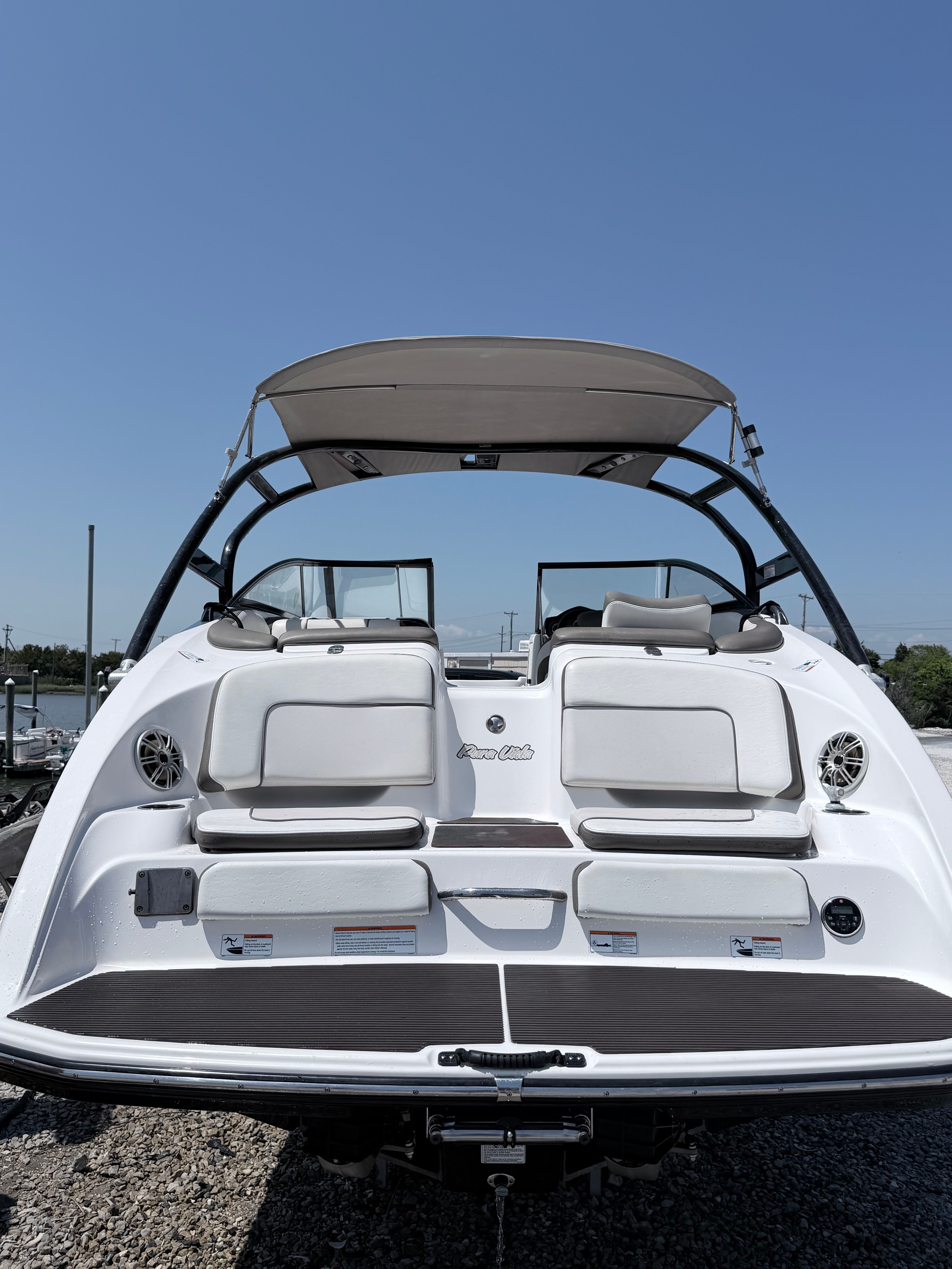 The image shows a 2014 Yamaha 242 Limited S boat on a gravel lot.