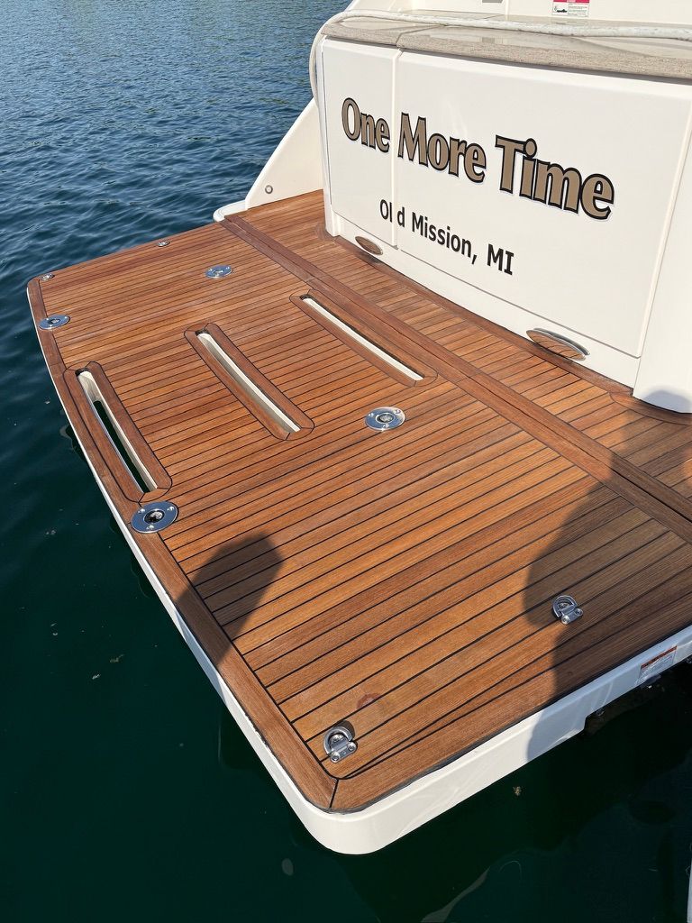 The 2017 Tiara Yachts C44 Coupe is docked, featuring a sleek wooden deck.