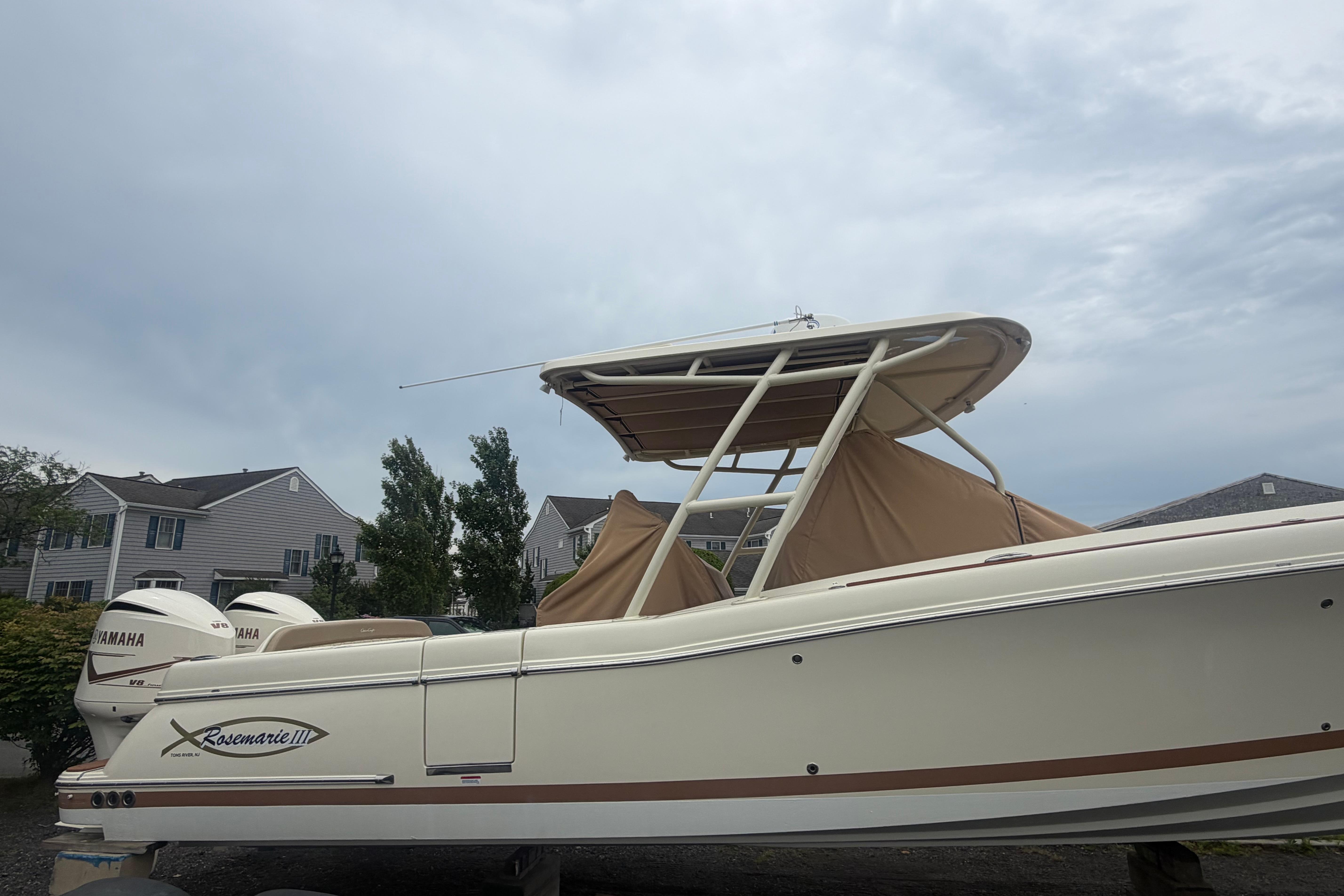 2017 Chris-Craft Catalina 34 boat with Yamaha engines, docked near residential area.