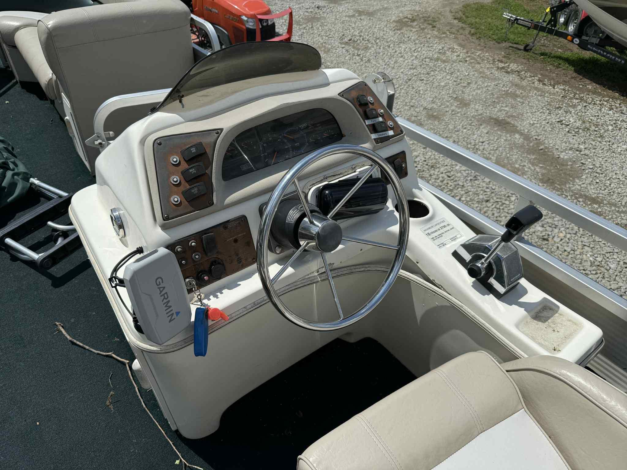 1999 Smoker Craft 8526 Pleasure Isle I/O boat dashboard with steering wheel and controls.