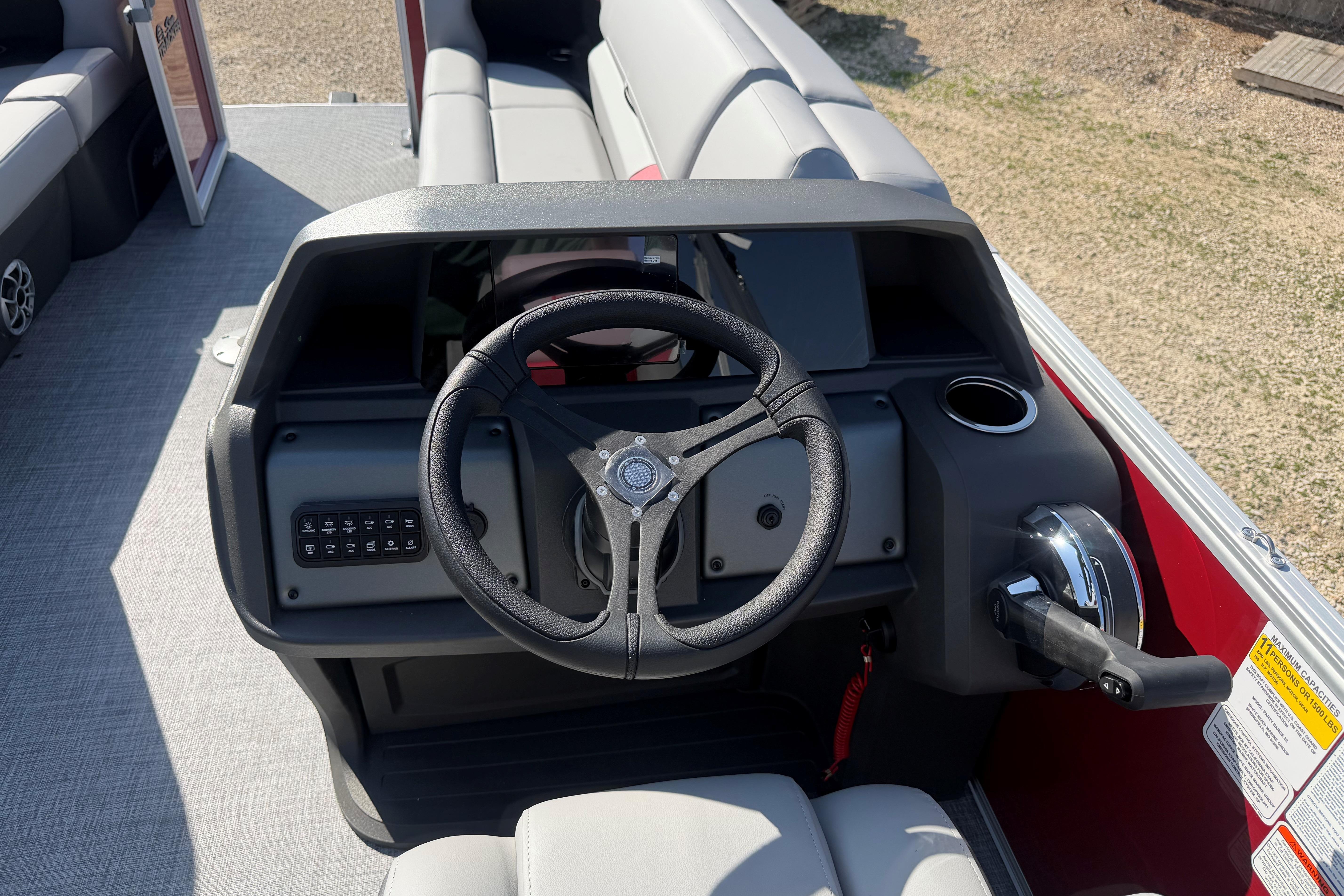 2026 Sun Tracker Party Barge 22 DLX steering console with modern controls and seating.