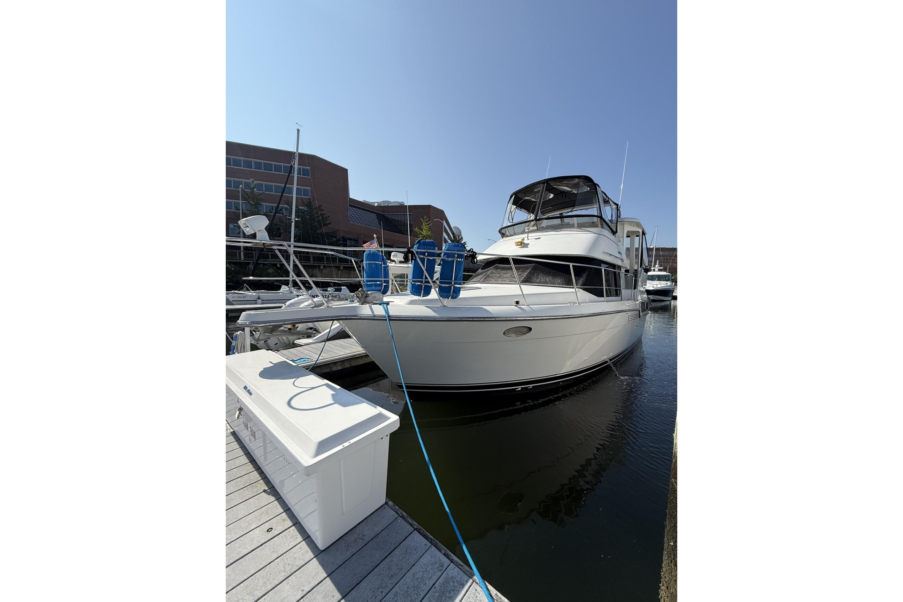 1993 Carver 350 Motor Yacht docked at marina under clear blue sky.