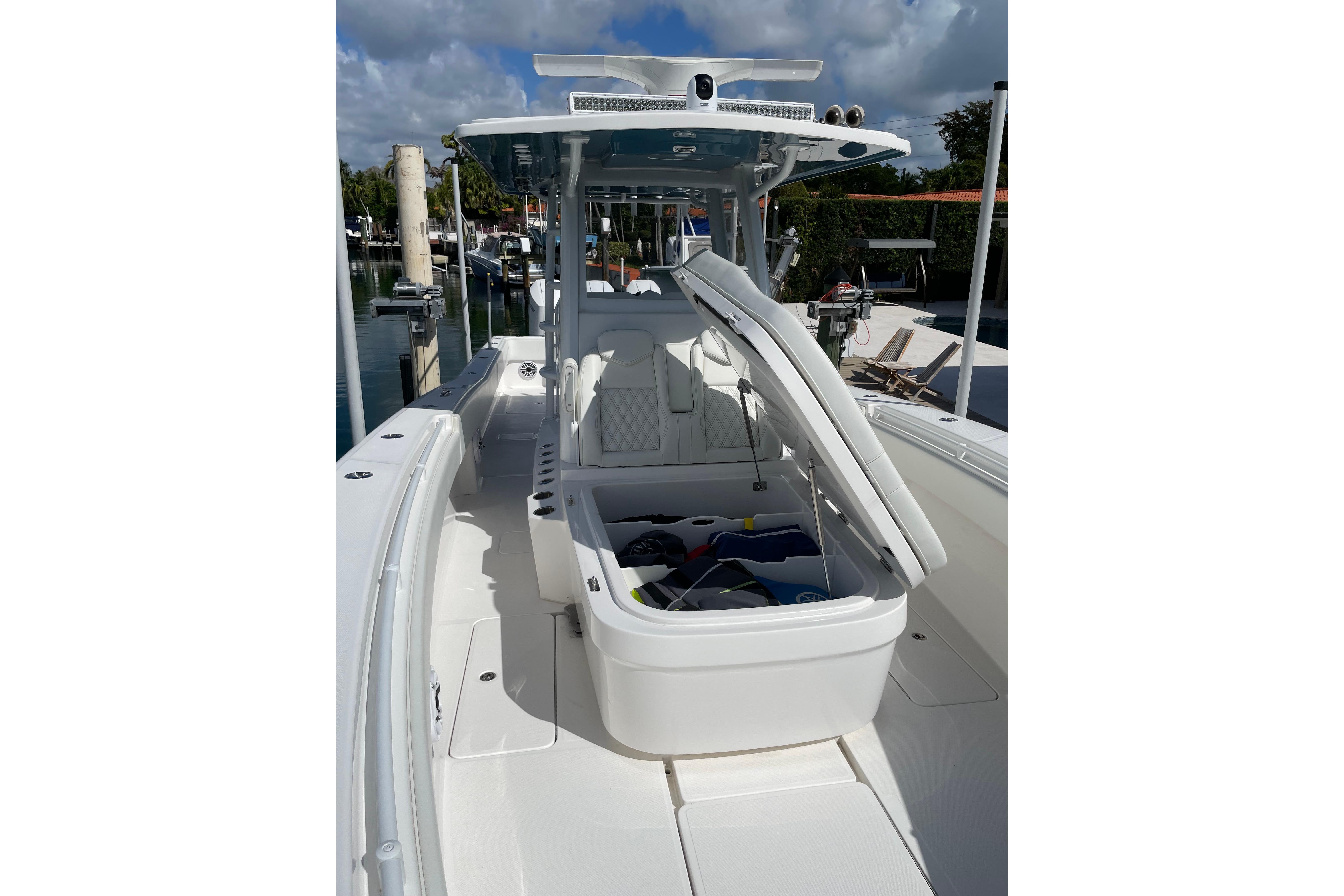 2024 Invincible 36 Open Fisherman boat with open storage compartment, docked at marina.
