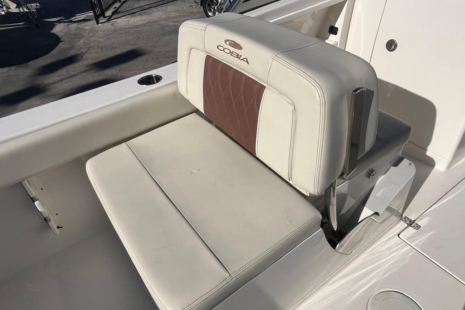 2023 Cobia 220 Dual Console boat seat with white and brown upholstery.