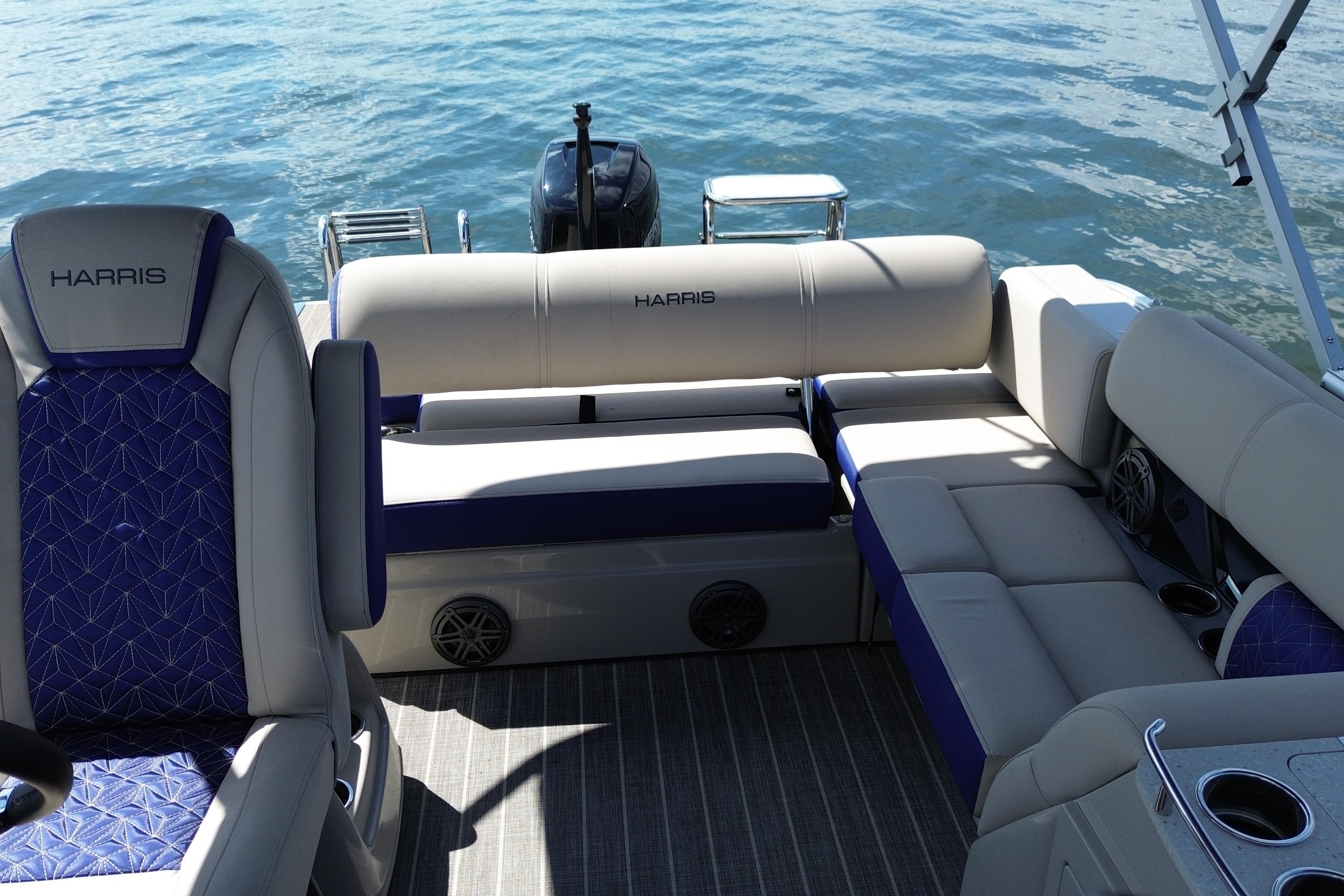 Luxury seating on 2022 Harris Grand Mariner 250 pontoon boat, with water in the background.