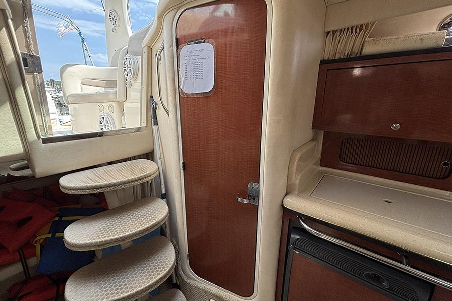 Interior of 2002 Sea Ray Sundancer 320 with steps, door, and cabinetry.