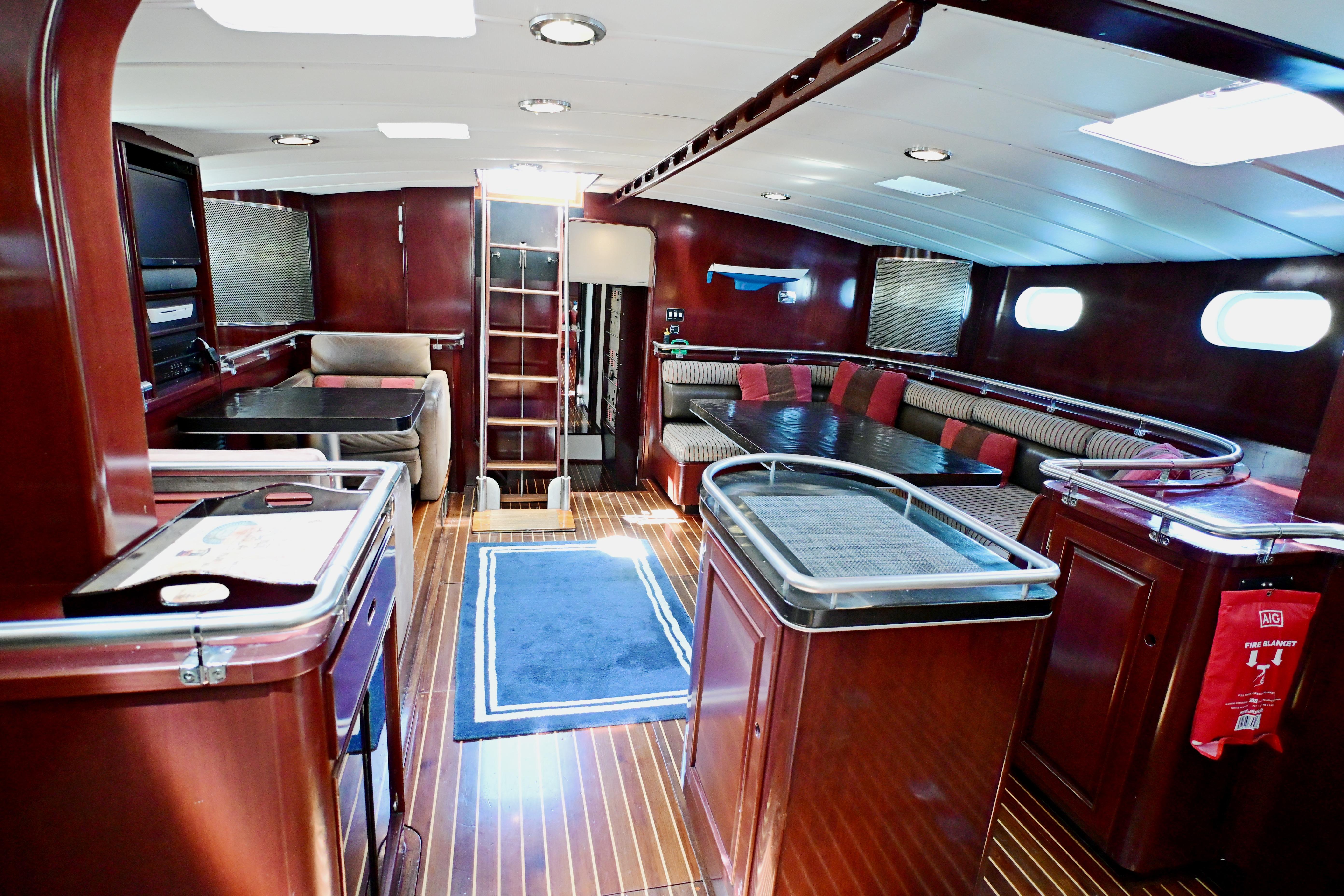 Luxurious interior of 1968 Abeking & Rasmussen Tripp 74 yacht with elegant wood finishes.