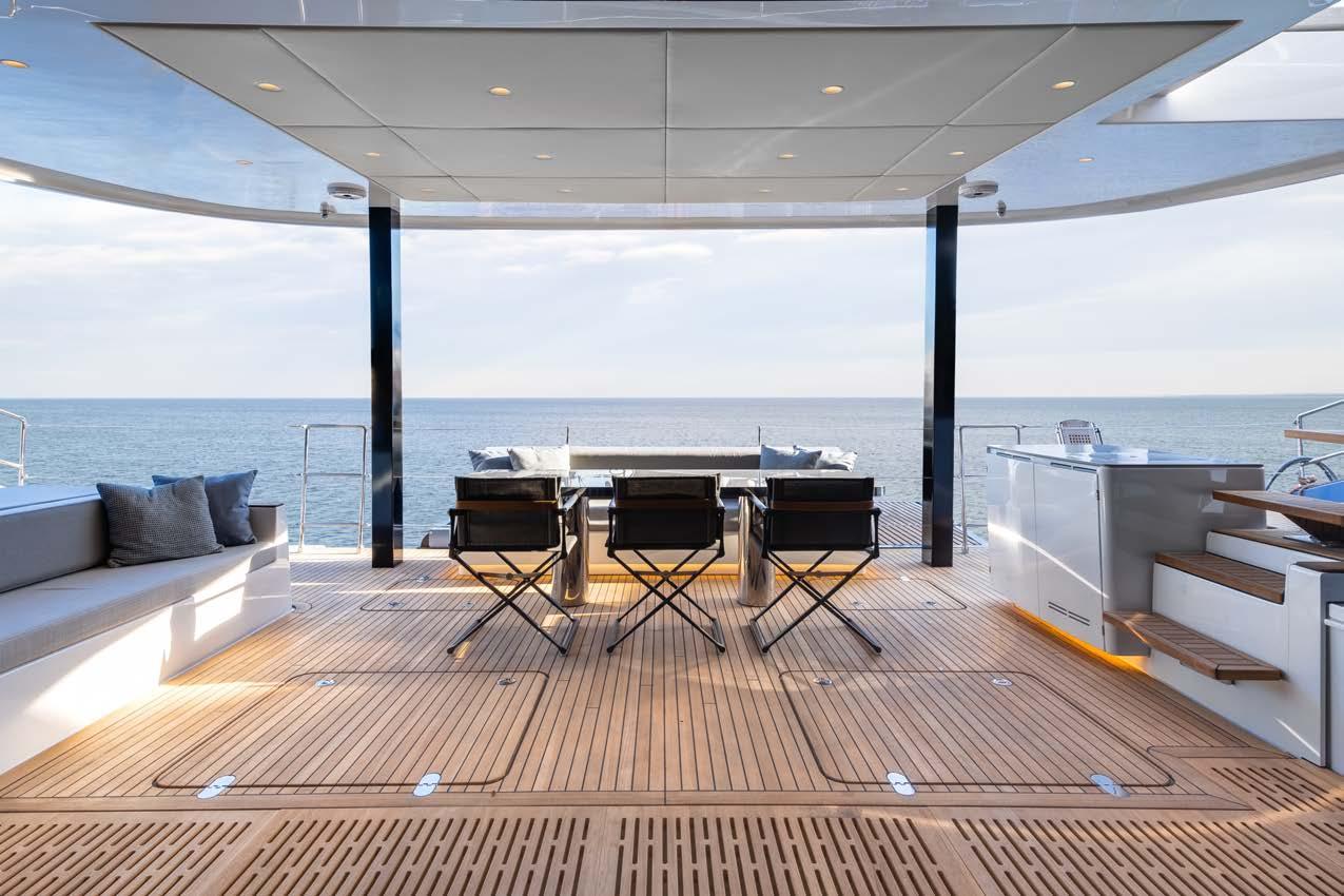 Luxurious Sunreef 70 Sailing yacht deck, 2023 model, with ocean view and elegant seating area.