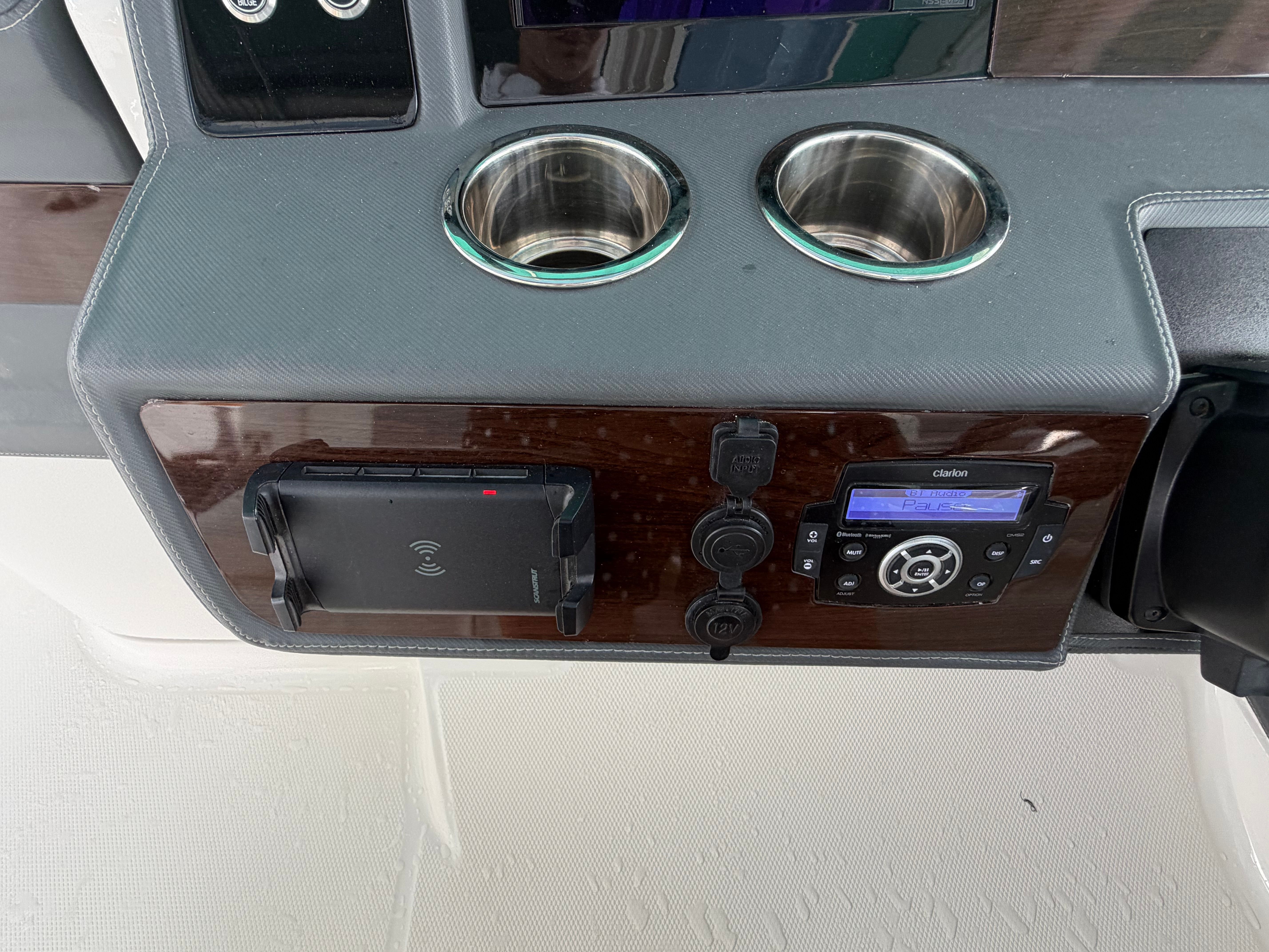 Boat dashboard with cup holders and controls.