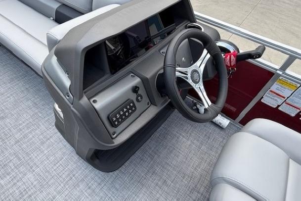 2026 Sun Tracker SportFish 20 DLX boat dashboard with steering wheel and controls.