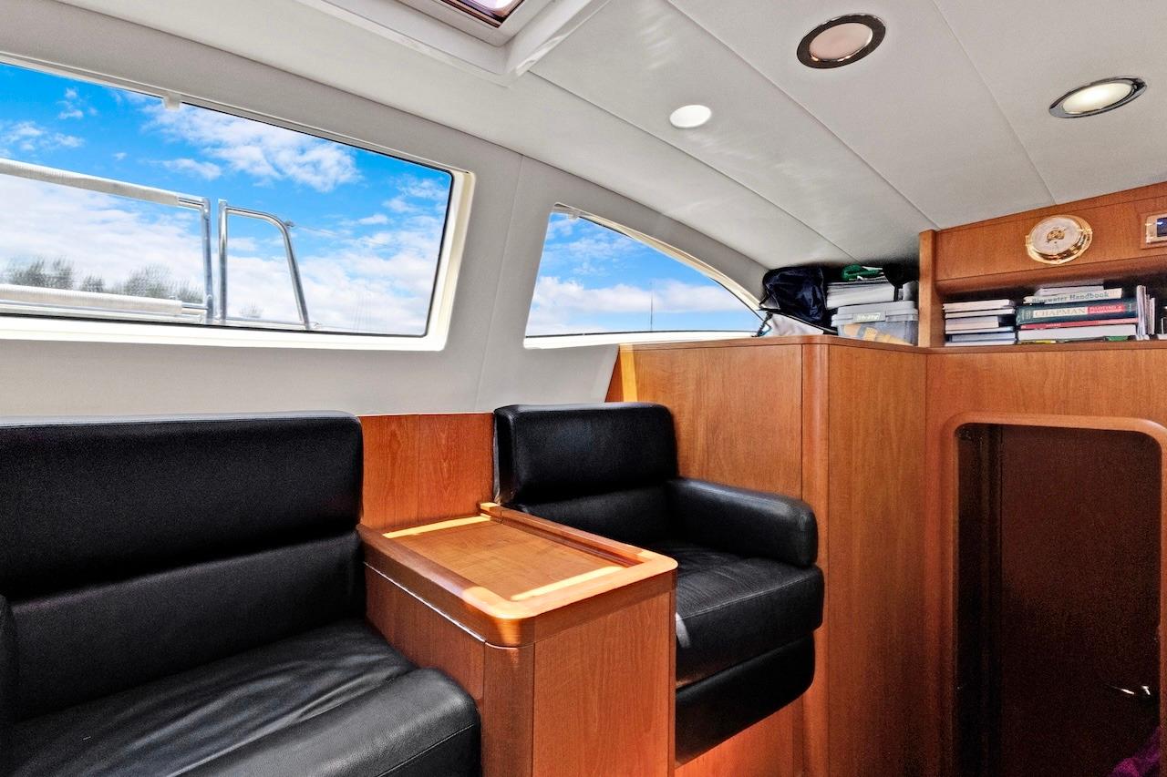 Interior of 2011 Southerly 57 RS yacht with black seating and wooden accents.