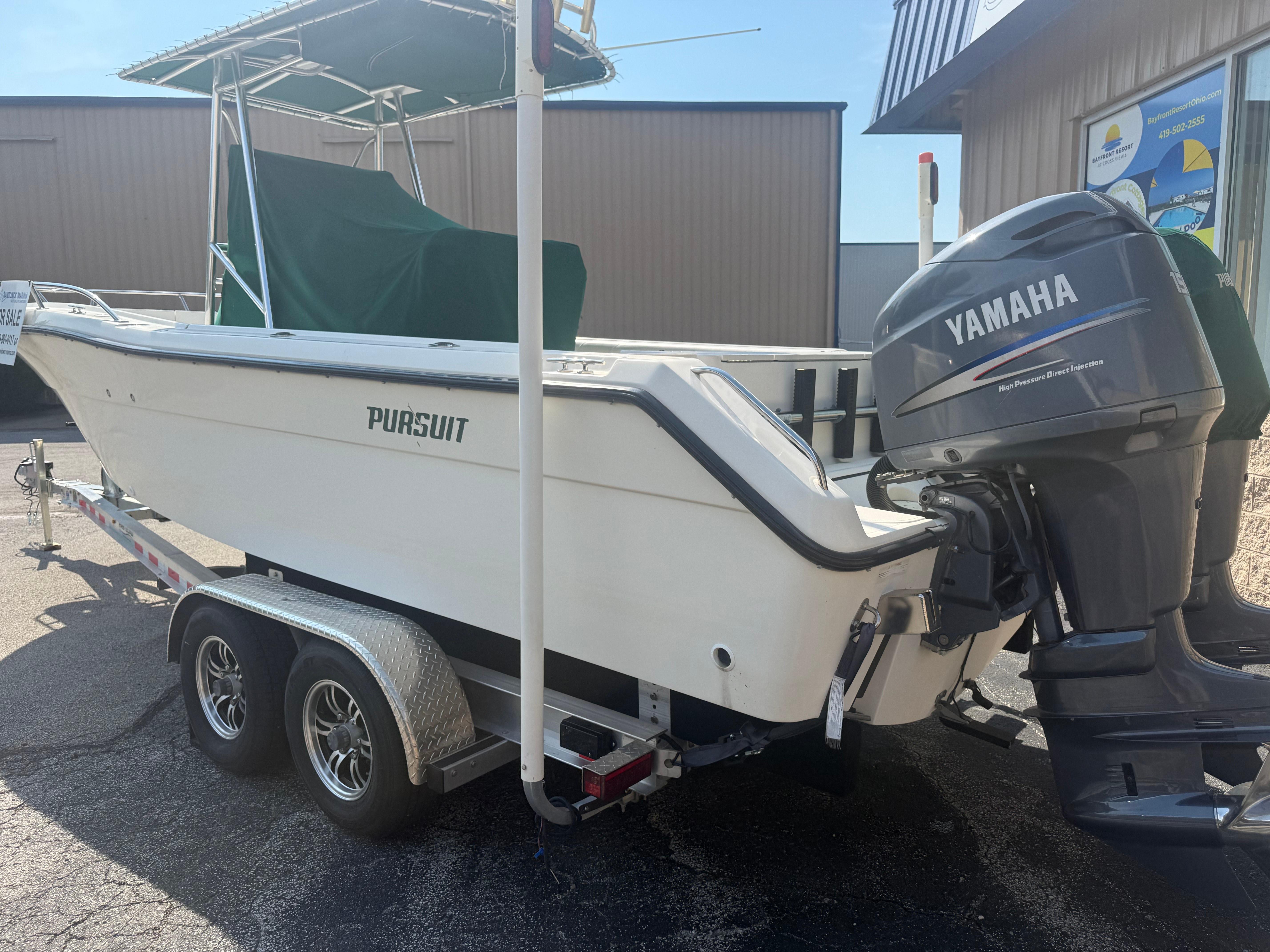 2002 Pursuit 2470 CC boat with Yamaha outboard motor on a trailer.
