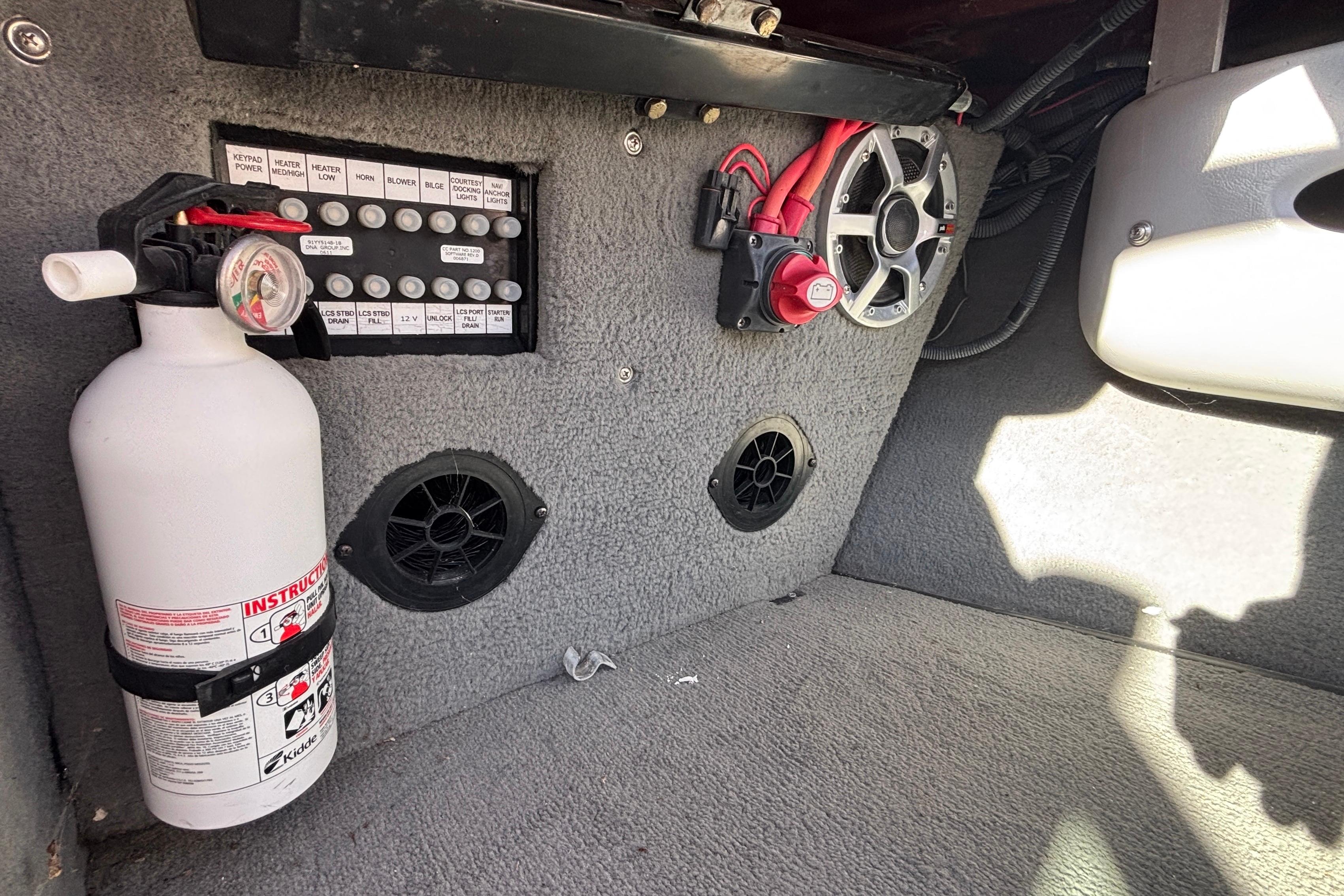2006 Nautique Ski Nautique 206 interior with fire extinguisher and control panel.
