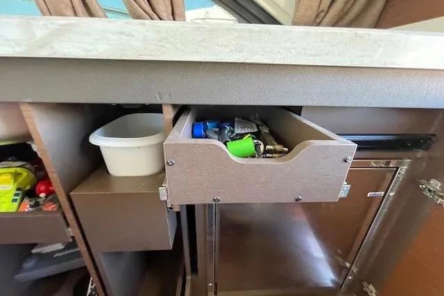 Interior storage of 2016 Sea Ray Sundancer 510 yacht with open drawer and cabinet.