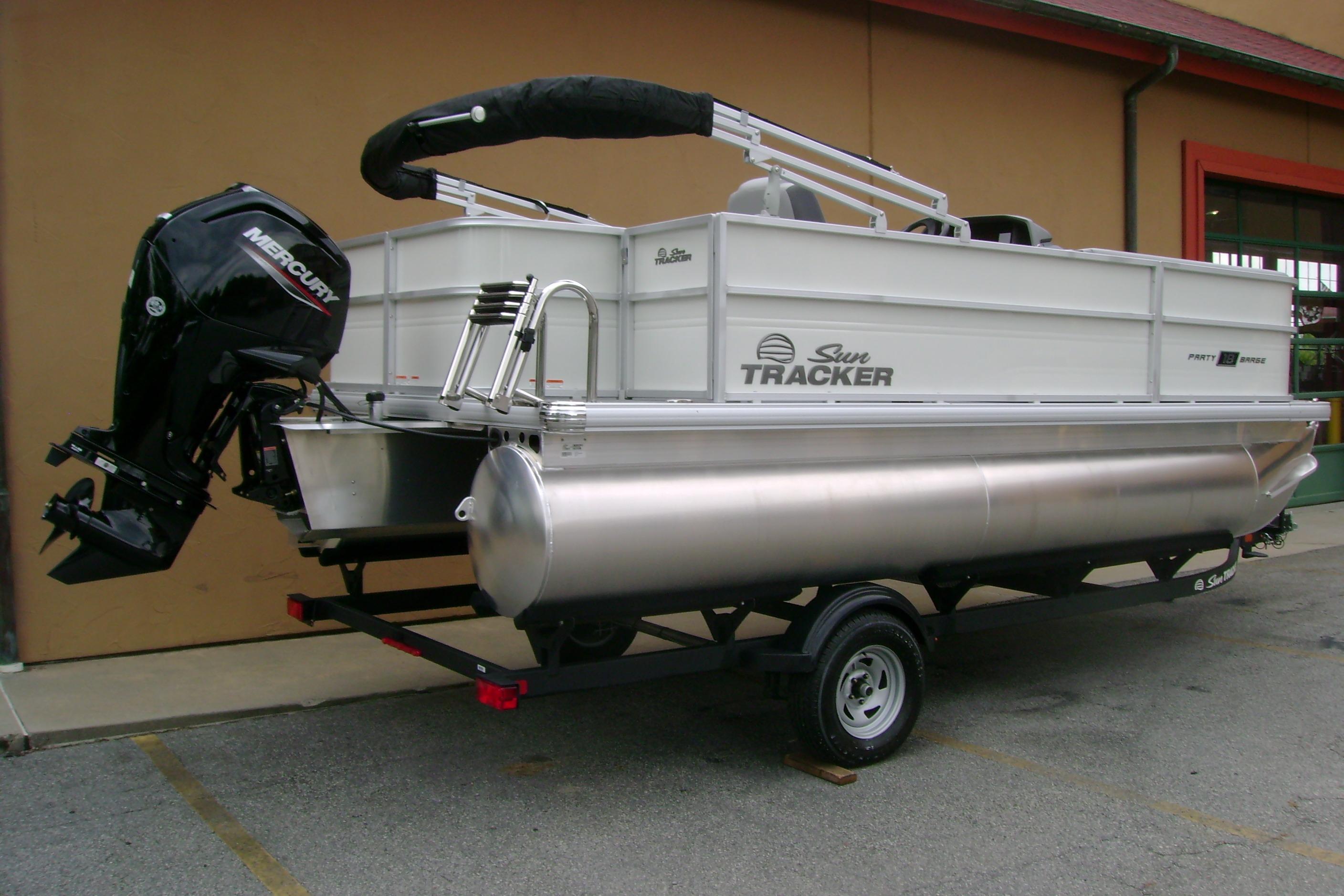 2026 Sun Tracker Party Barge 18 DLX pontoon boat with Mercury outboard motor on trailer.