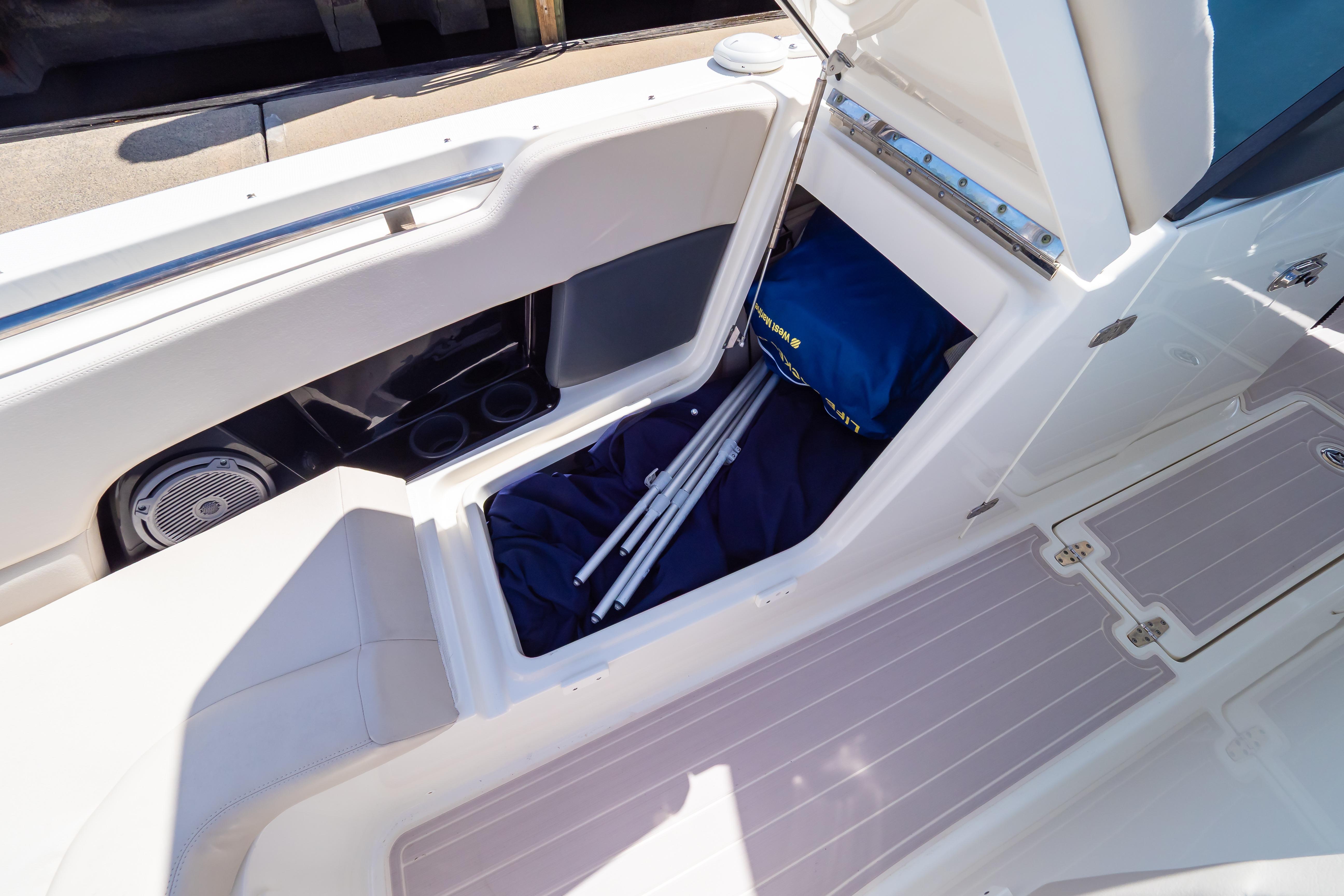 2019 Boston Whaler 270 Vantage boat storage compartment with gear and accessories.