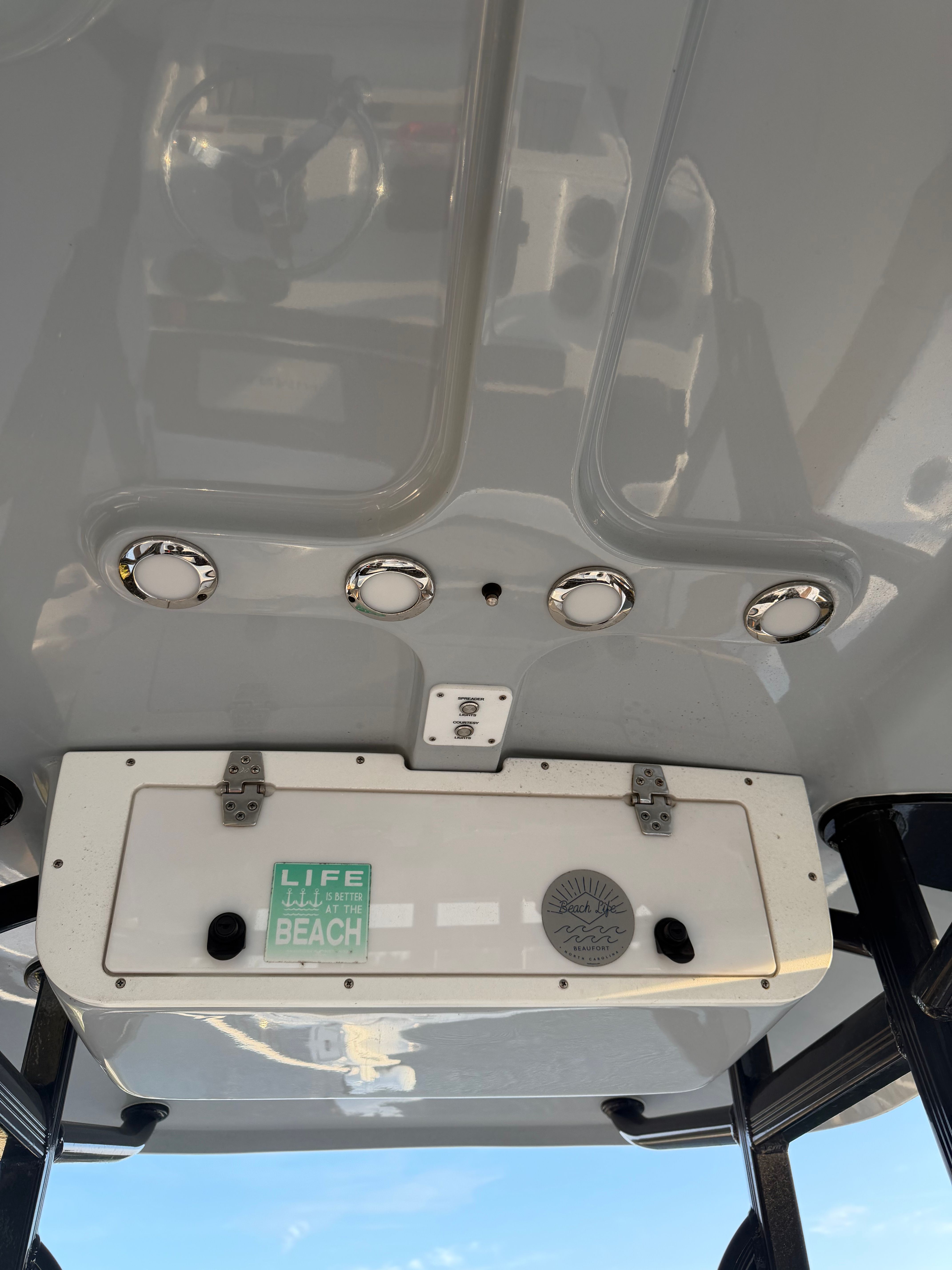View of a boat's roof with built-in lights and a storage compartment.