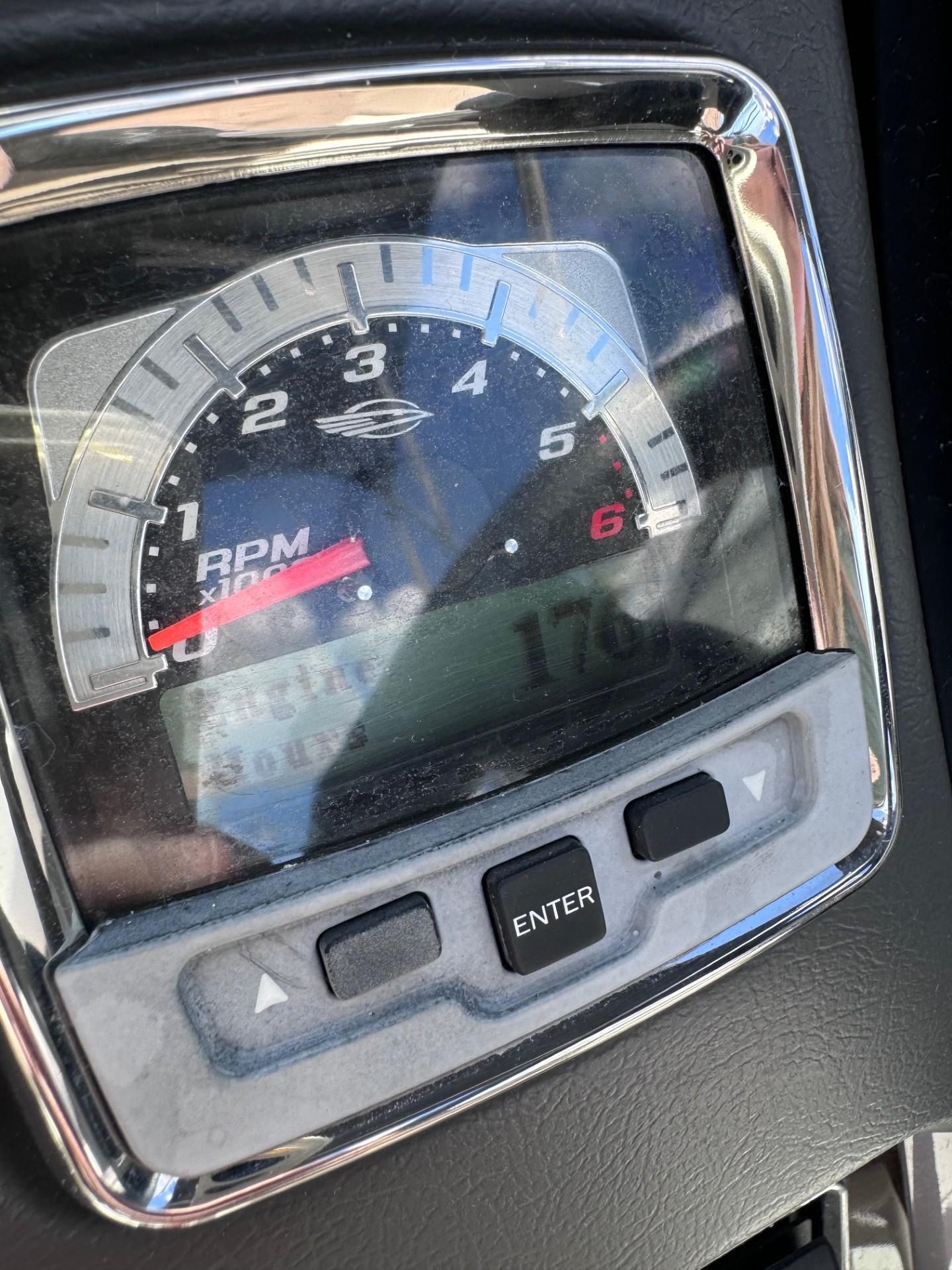Close-up of a tachometer with digital display and control buttons.
