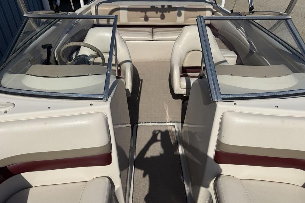 1999 Glastron GT 225 boat interior with dual windshields and seating.