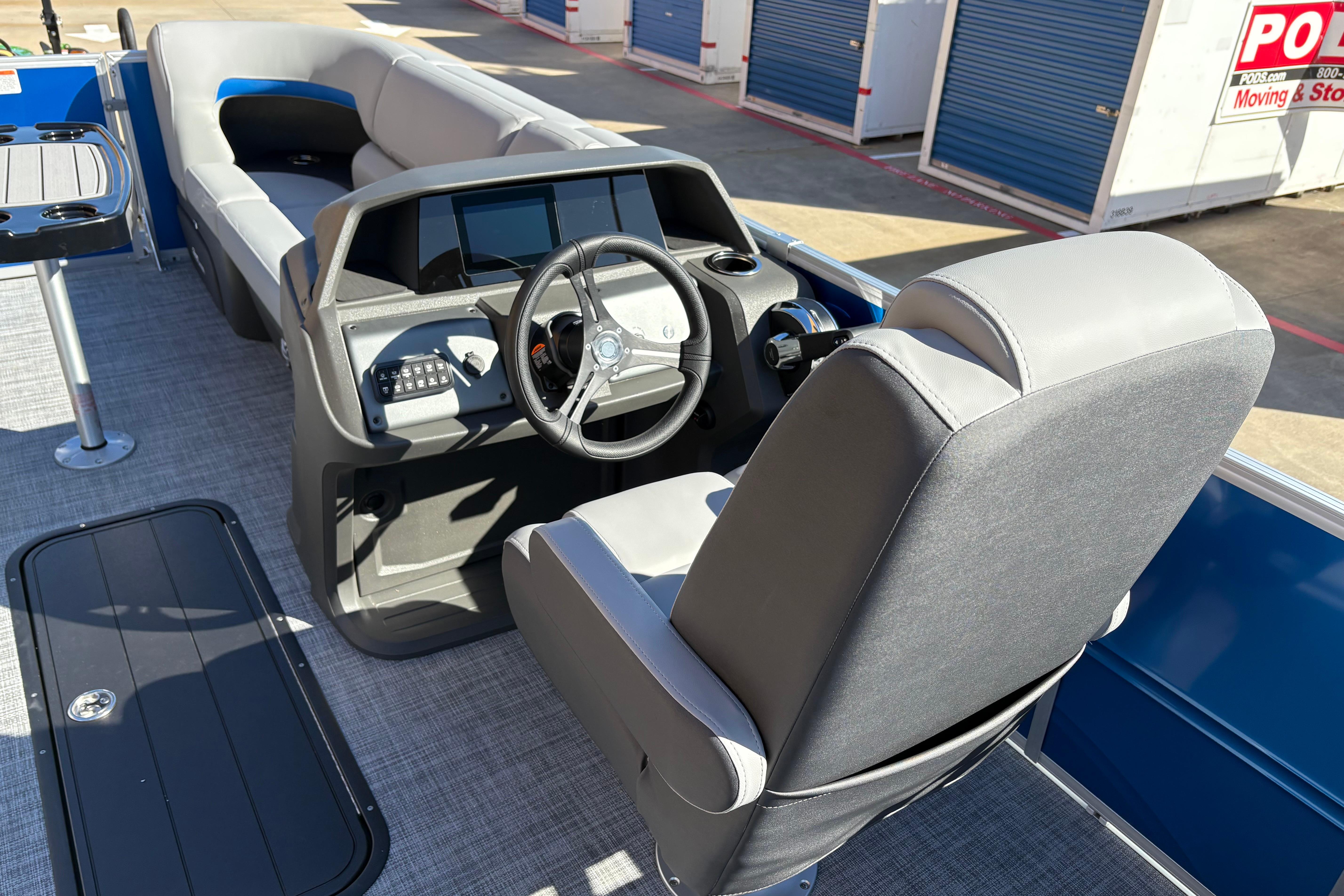 2026 Sun Tracker Party Barge 22 RF XP3 interior with steering console and seating.