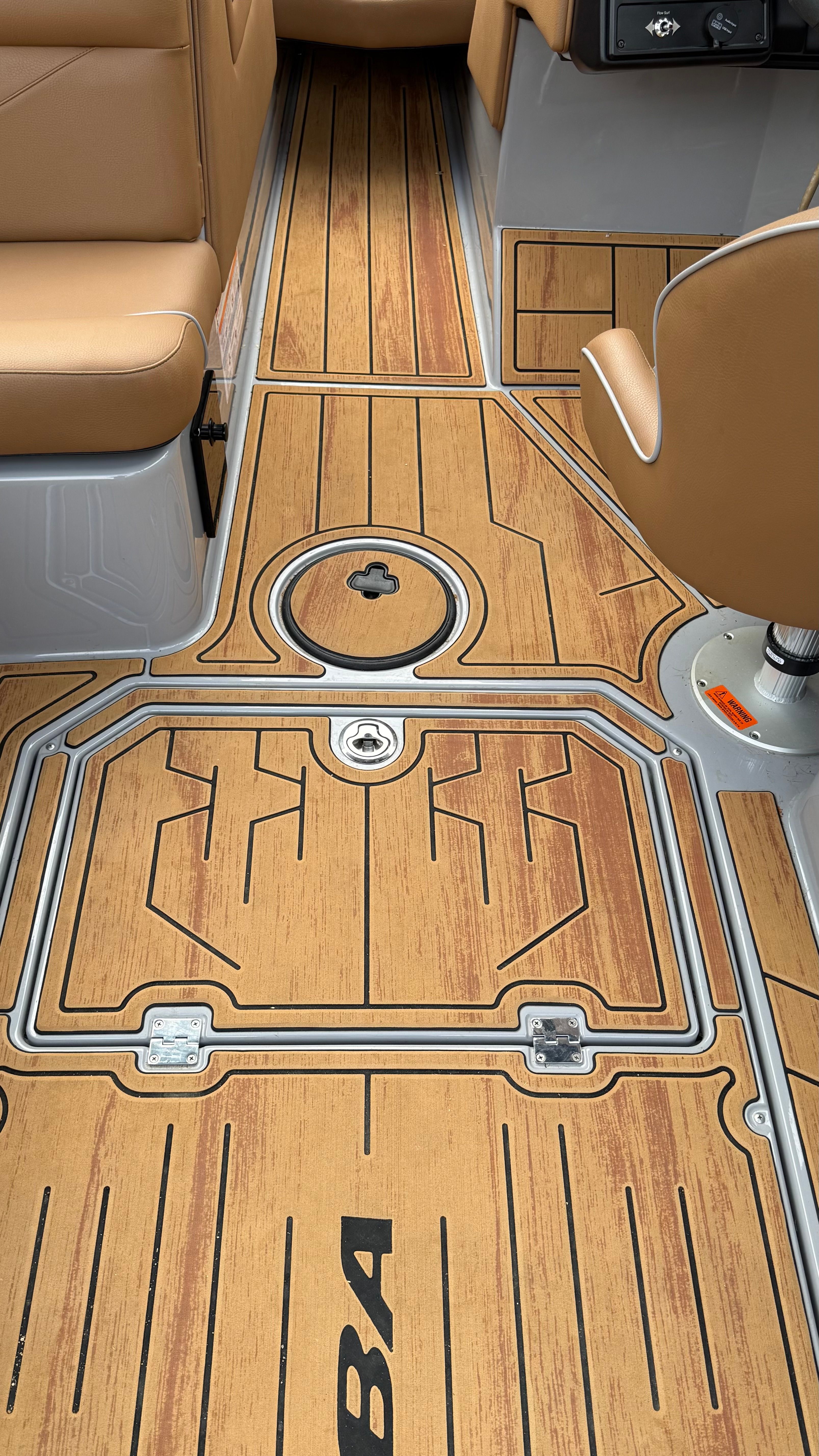 Interior of a 2025 Malibu Mojo with stylish wood flooring and beige seating.