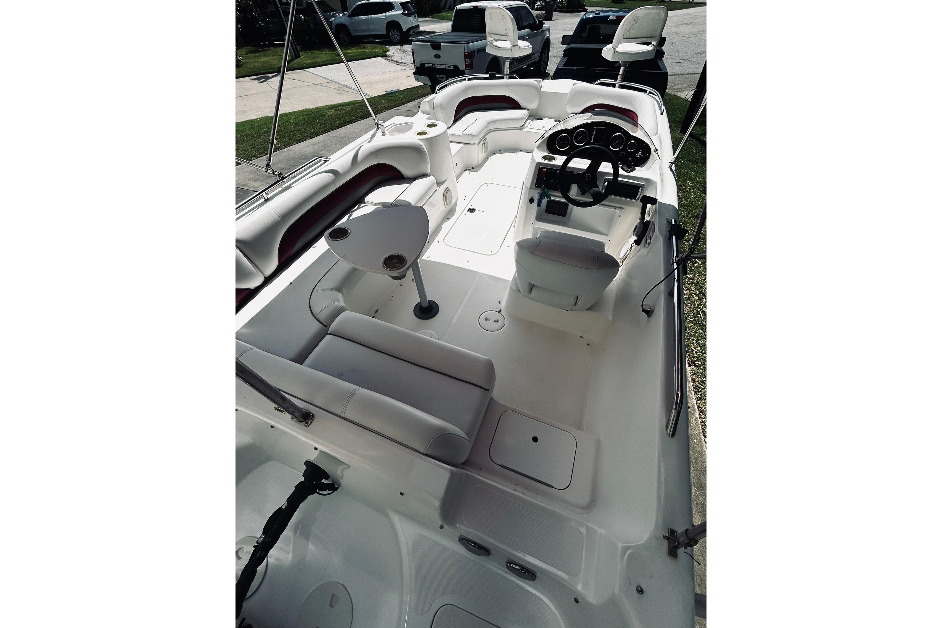 2013 Hurricane SunDeck Sport 201 OB boat interior with seating and steering console.