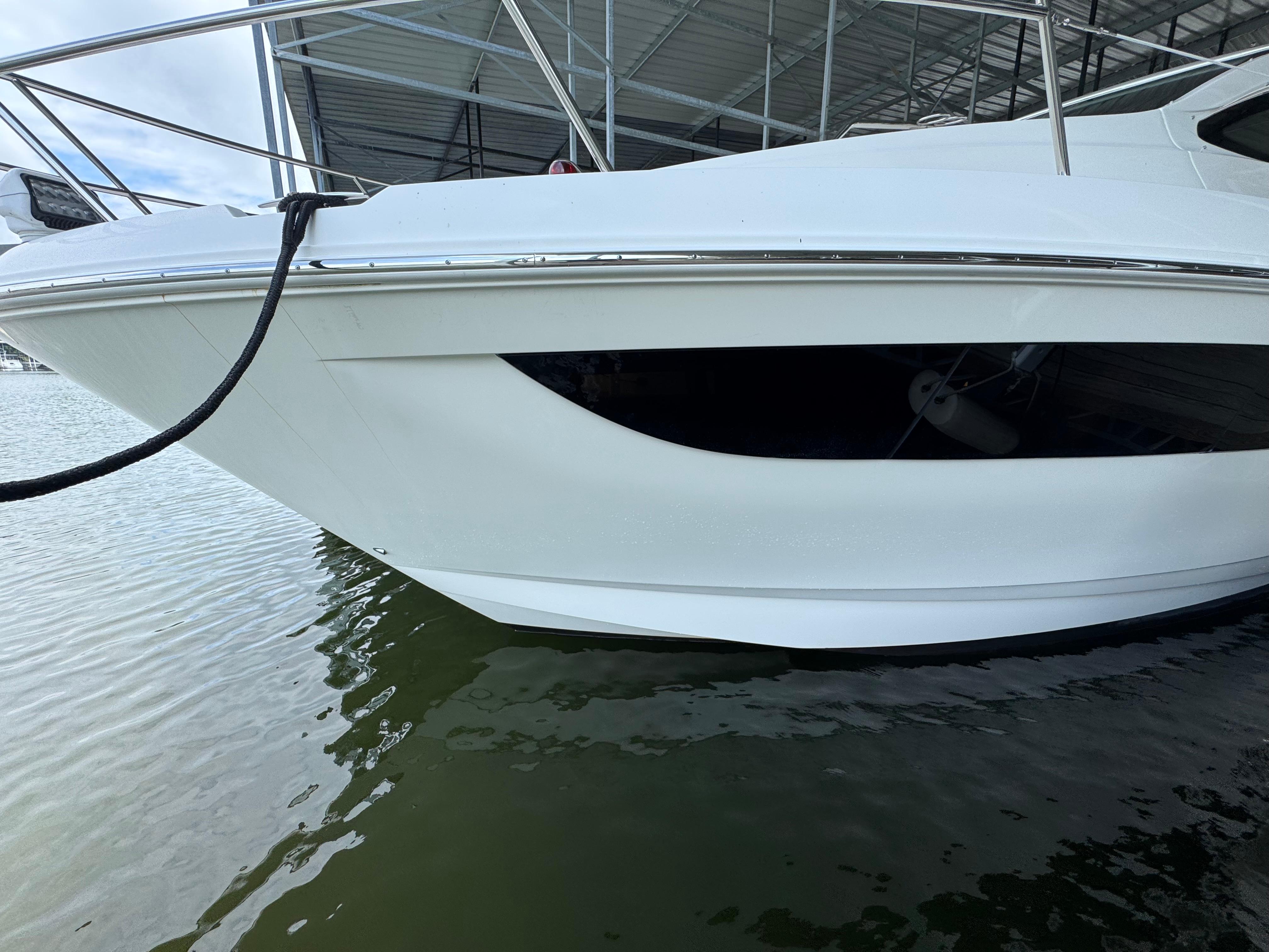 2017 Sea Ray Sundancer 400 yacht docked in marina, side view.