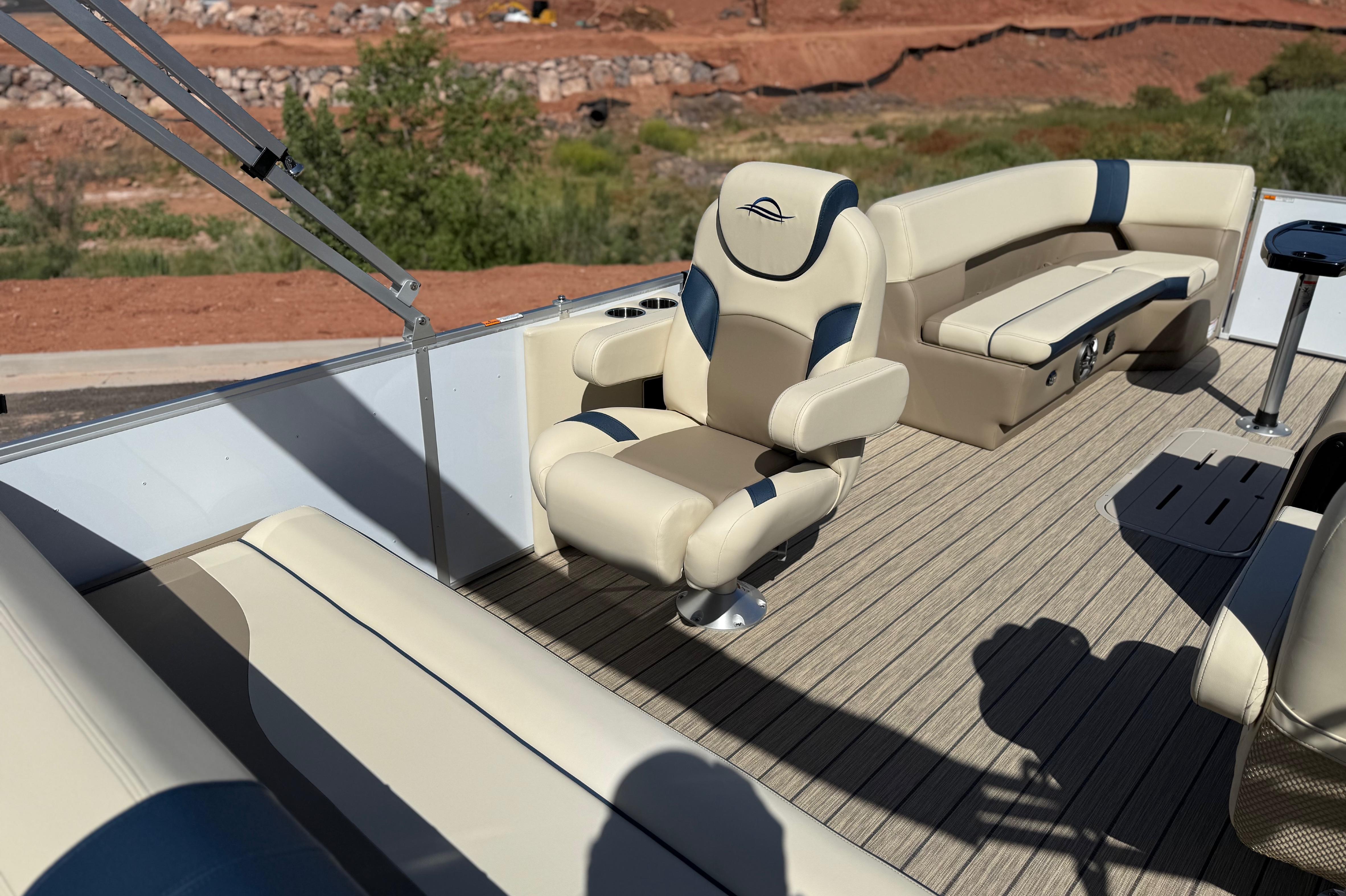 2026 SunCatcher Select 322SL pontoon boat interior with beige seating and wood-style flooring.