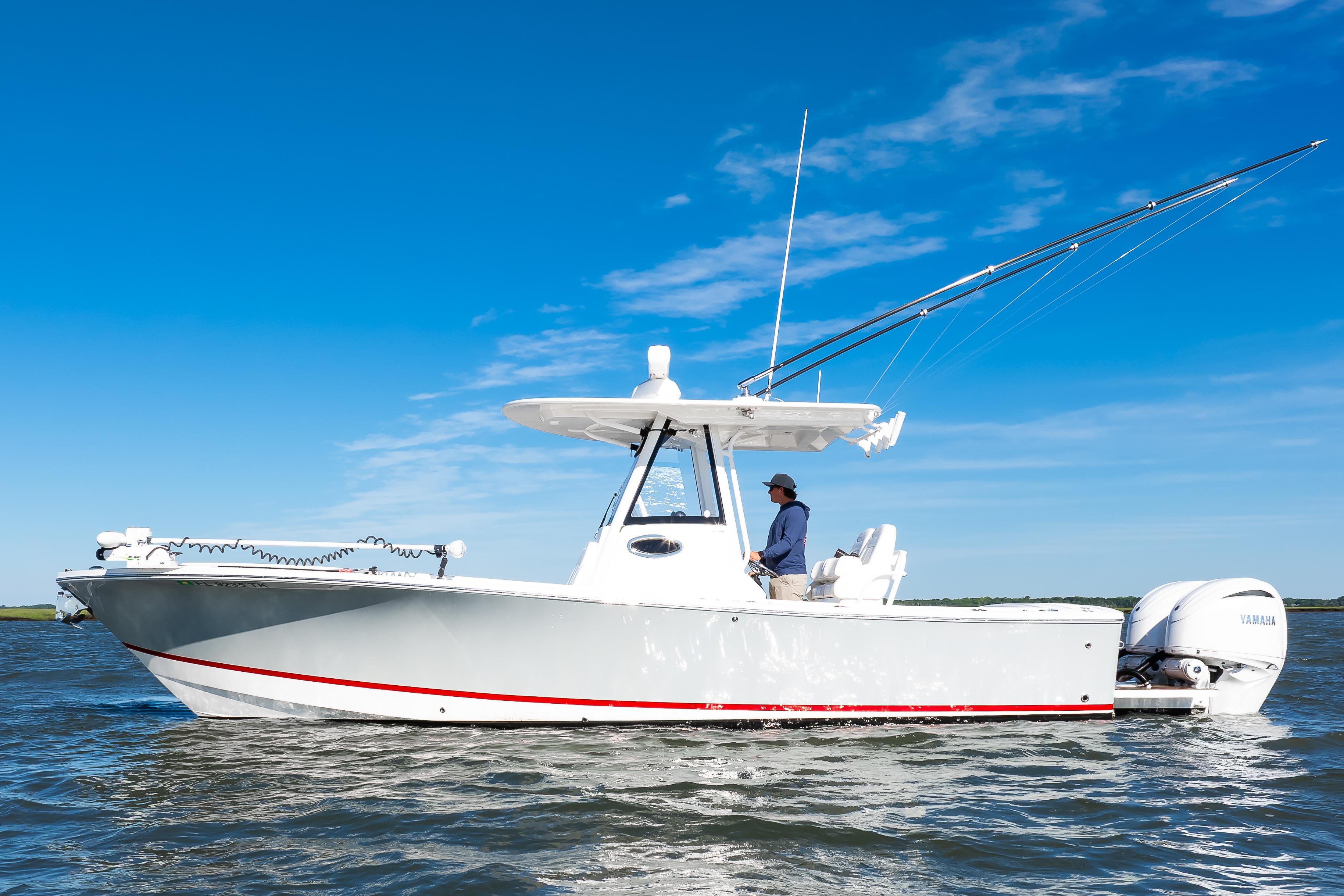 2022 Regulator 28 Forward Seating boat on water, clear blue sky background.