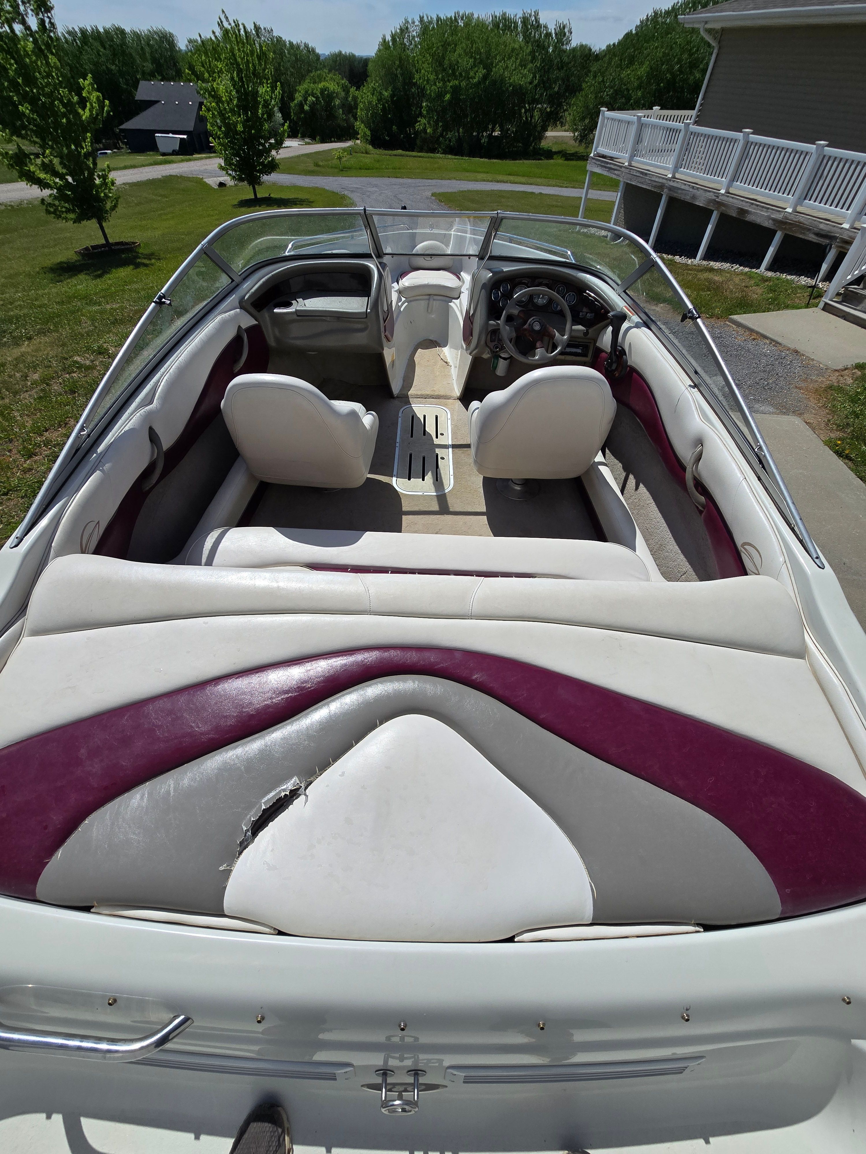 The image shows the interior of a 2001 Crownline 180 BR boat with white and purple seats.