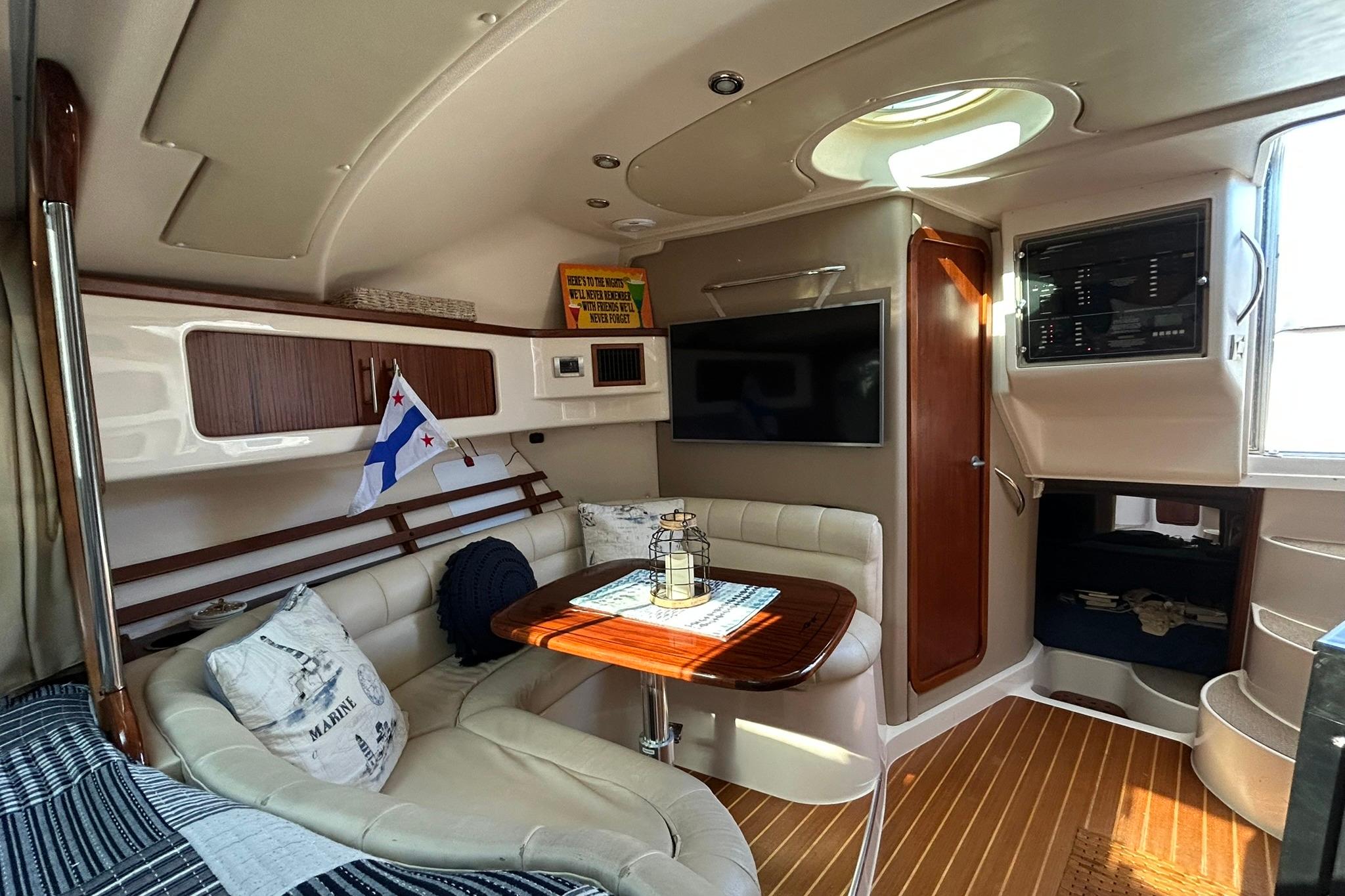 Luxurious 2007 Grady-White Express 360 cabin interior with seating, table, and nautical decor.