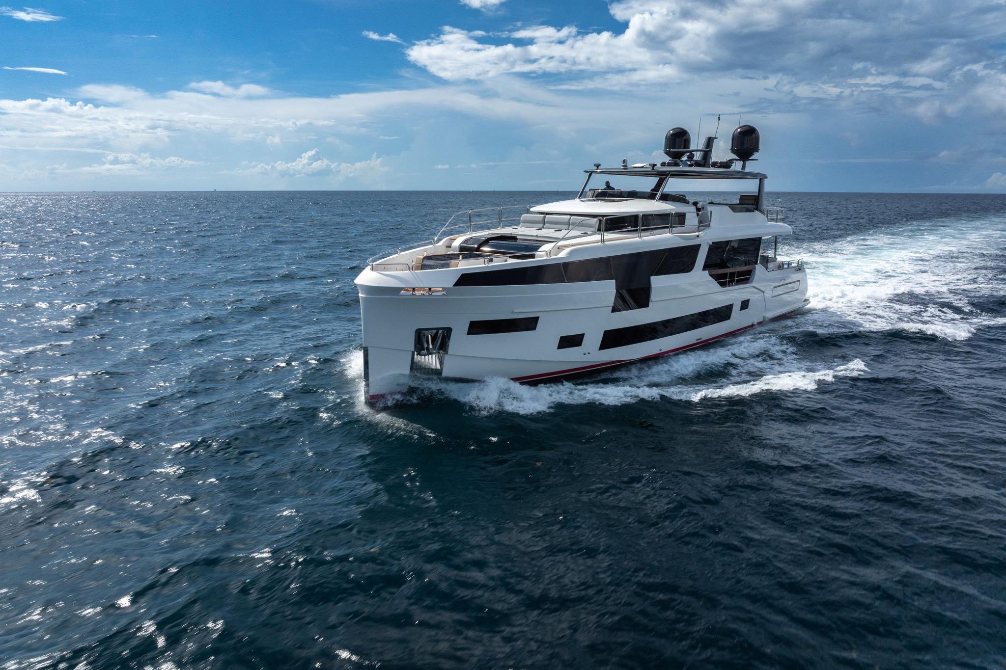 Luxury Sirena 88 yacht cruising on open sea under clear blue sky, 2021 model.