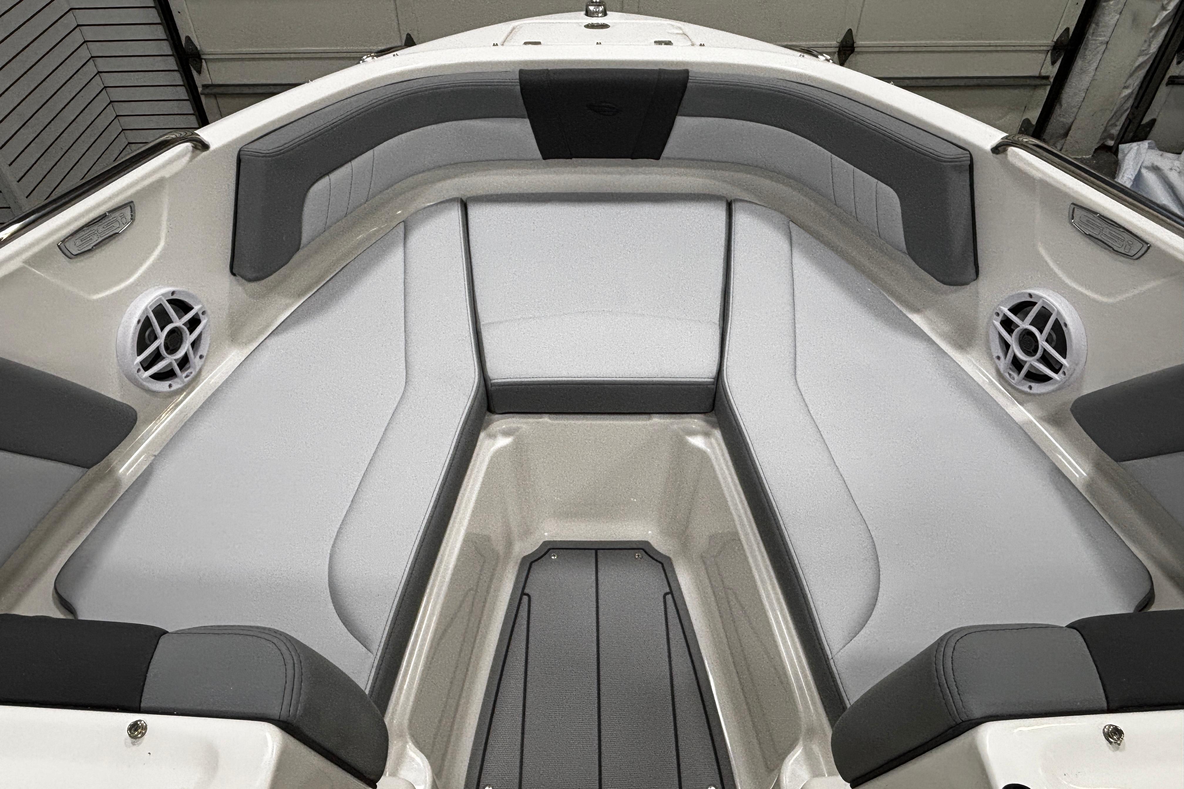 2026 Chaparral 21 SSi boat interior with gray seating and speakers.