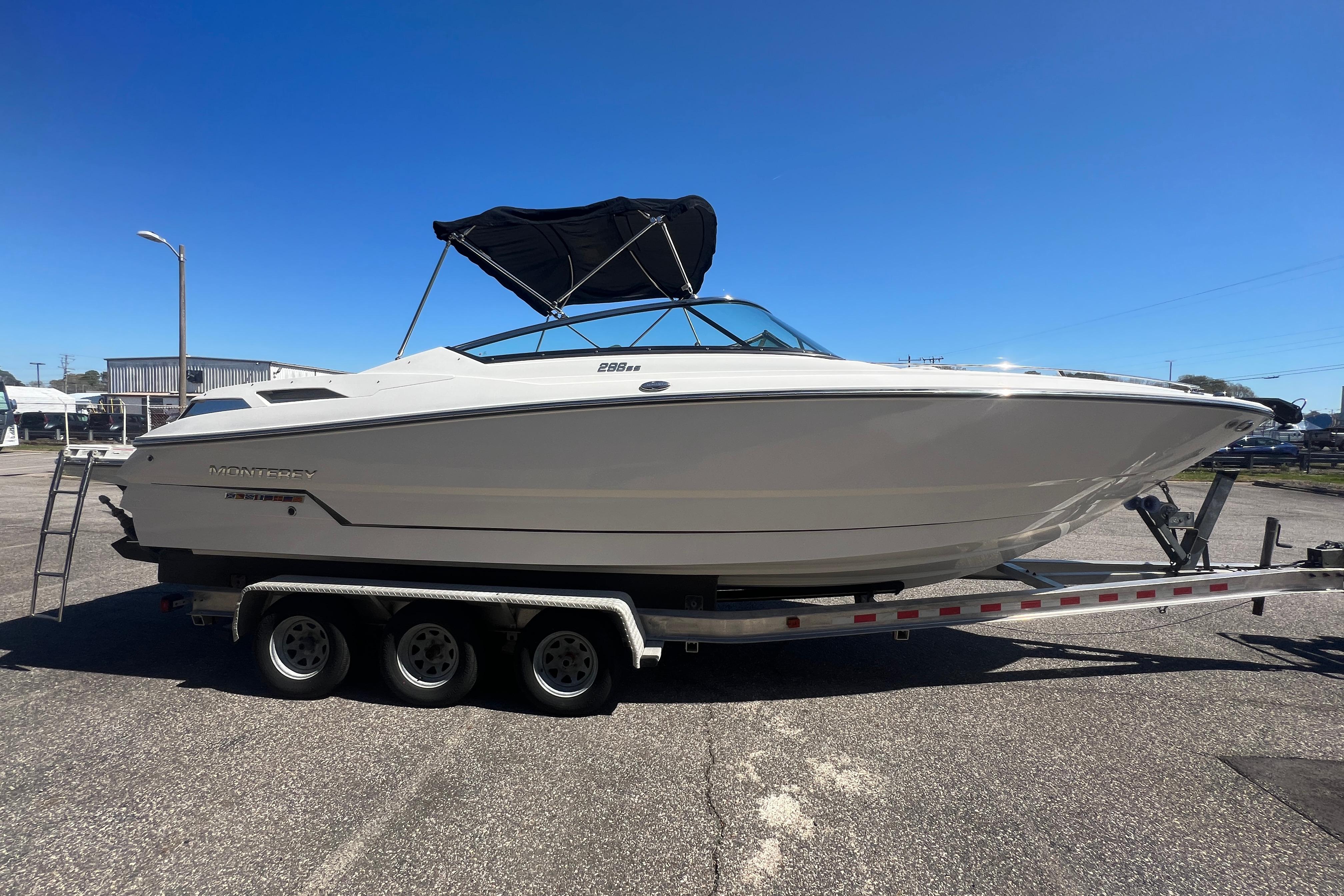 2017 Monterey 298SS Super Sport boat on trailer under clear blue sky.
