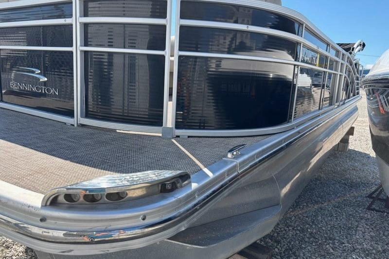 2014 Bennington 2575 RCW pontoon boat with sleek design and metallic accents.