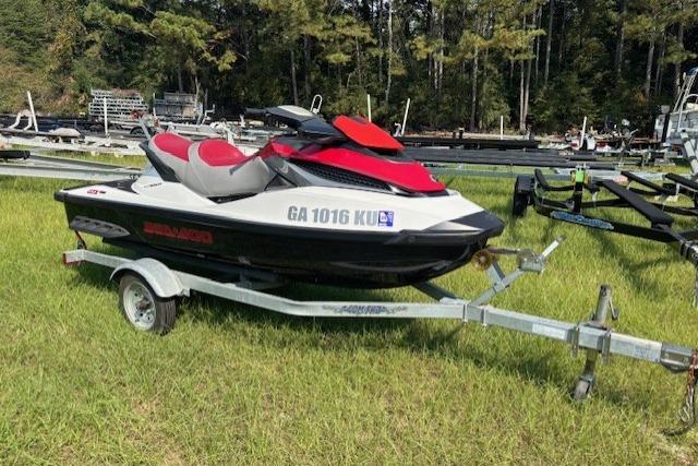 2010 Sea-Doo GTX 155 jet ski on trailer, parked on grass.