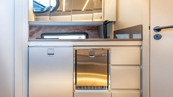 Modern kitchen interior in 2025 Hanover 415 RV with stainless steel appliances.