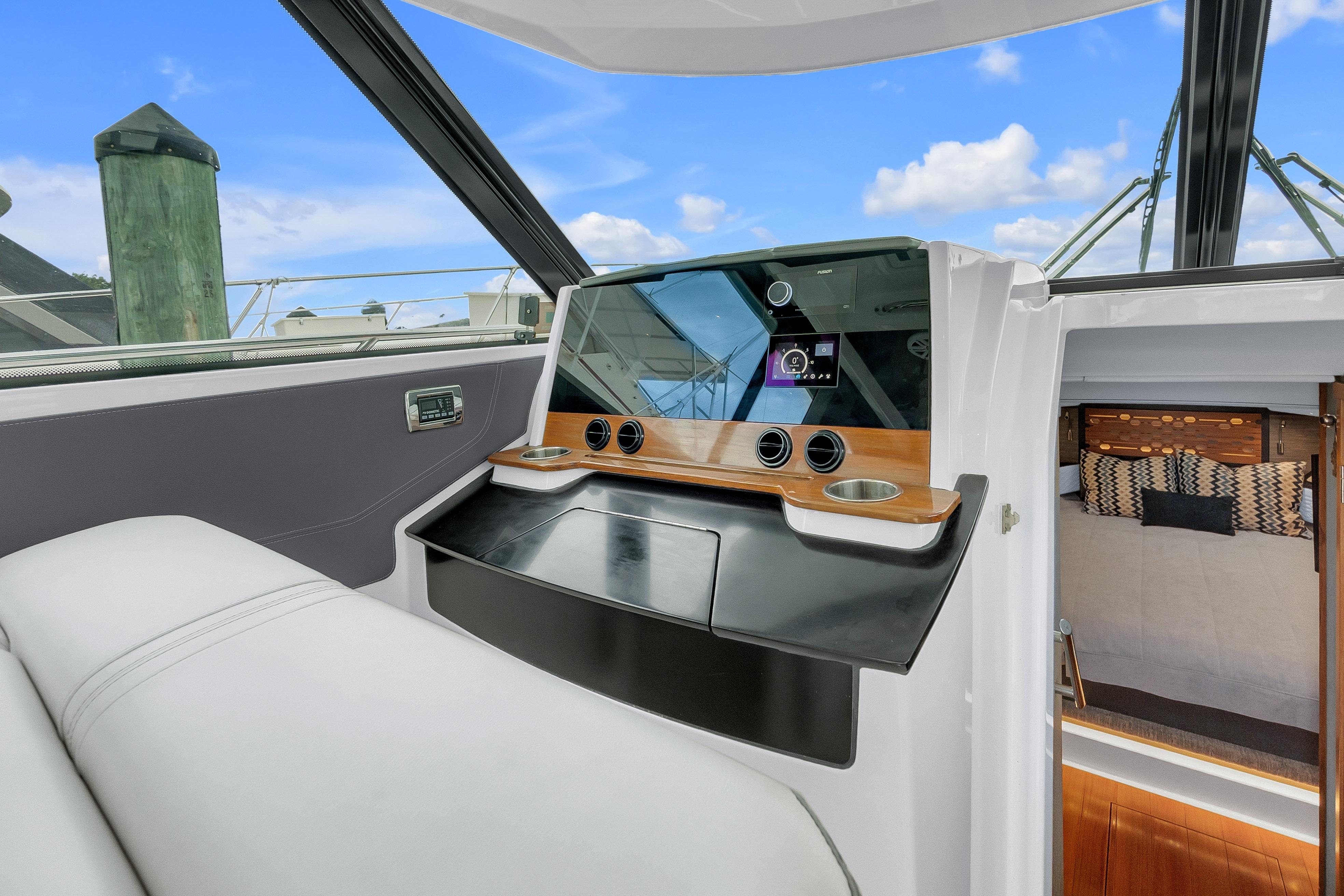 2021 Tiara Sport 43 LE yacht interior with modern dashboard and cozy cabin view.