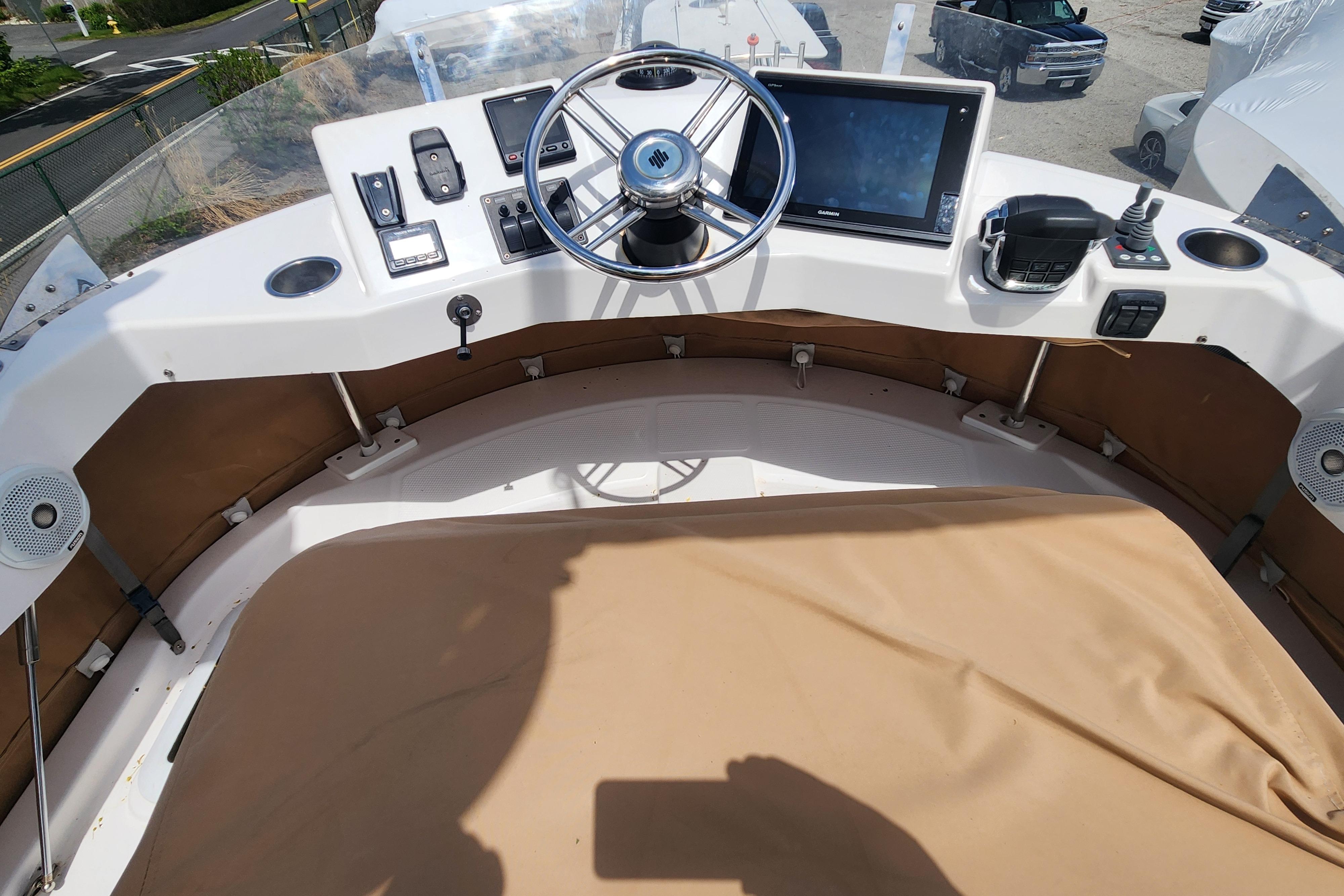 2019 Ranger Tugs R-31 CB helm with steering wheel, controls, and navigation display.