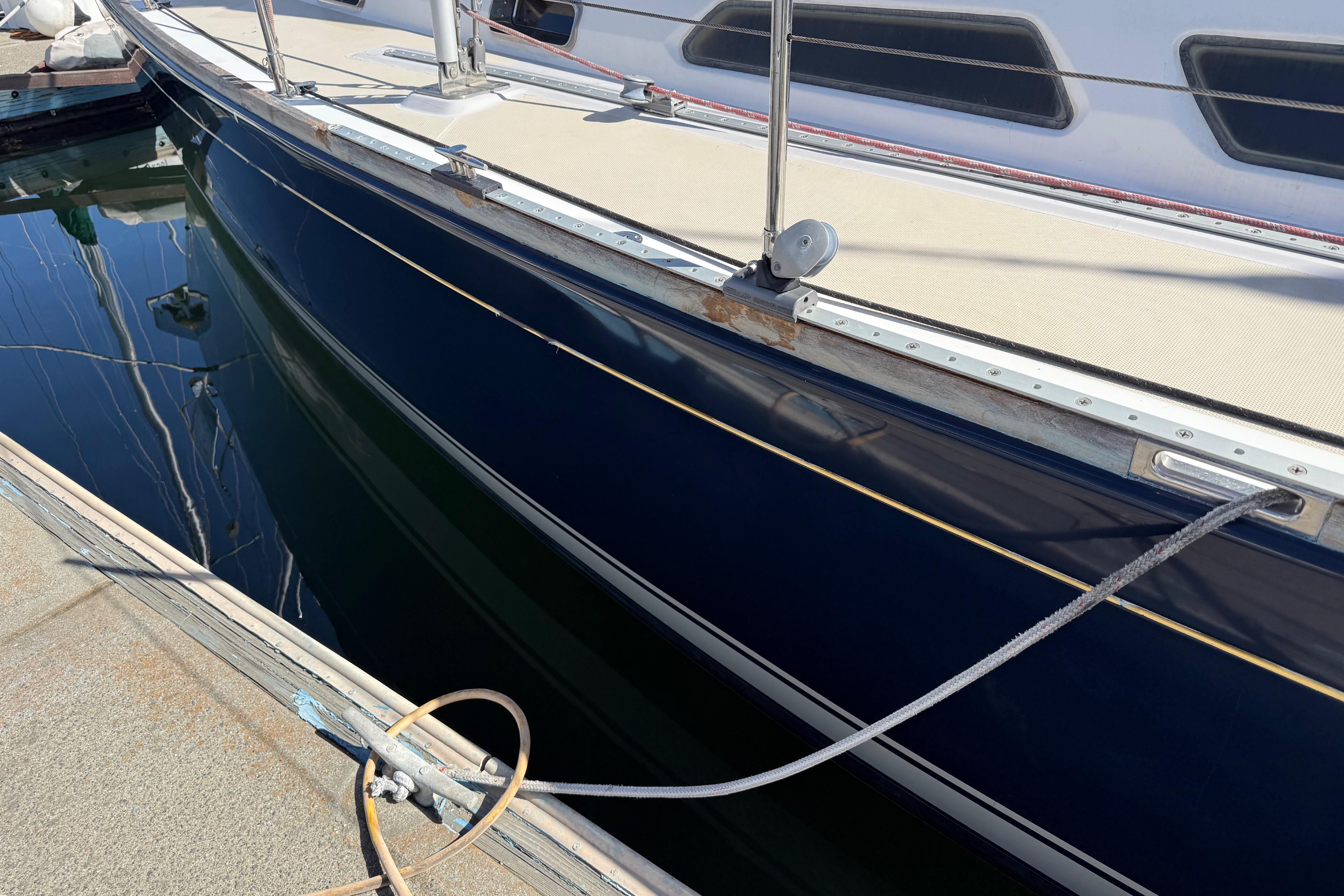 2004 Sabre 386 sailboat docked, showcasing sleek navy hull and deck details.