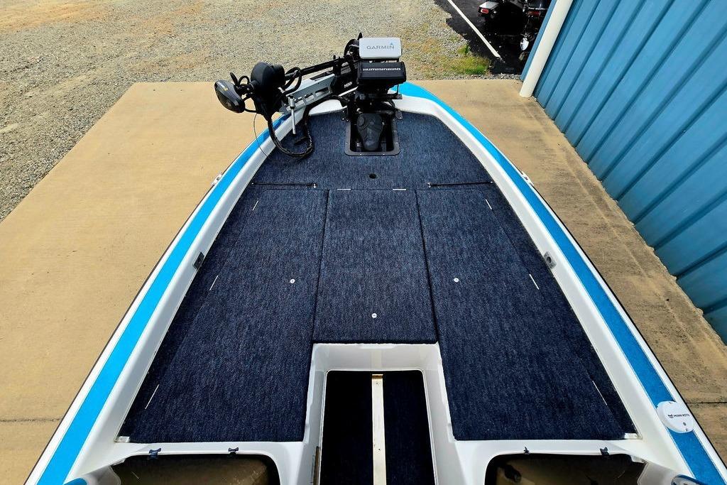 1996 Champion 181 SX boat deck with Garmin equipment, blue carpeting, and trolling motor.